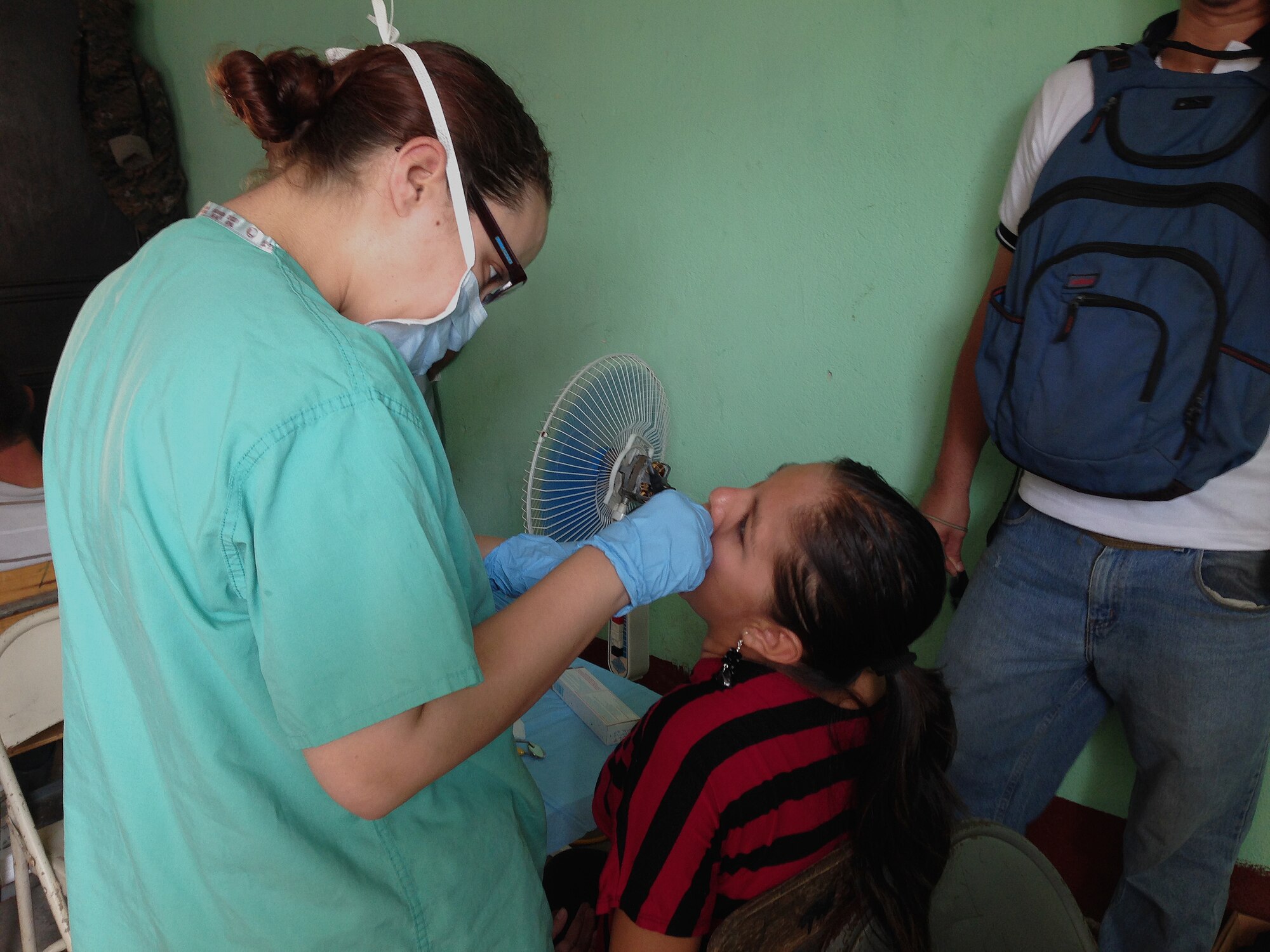 Staff Sgt. Amanda Gidaly, 22nd Aerospace Medicine Squadron clinical element NCO in charge, performs a prophylaxis procedure on a patient in Zacapa, Guatemala, April 28, 2014. Gidaly was part of a six Airmen team TDY from McConnell Air Force Base, Kan. to provide humanitarian assistance during medical readiness training exercises. (Courtesy Photo)