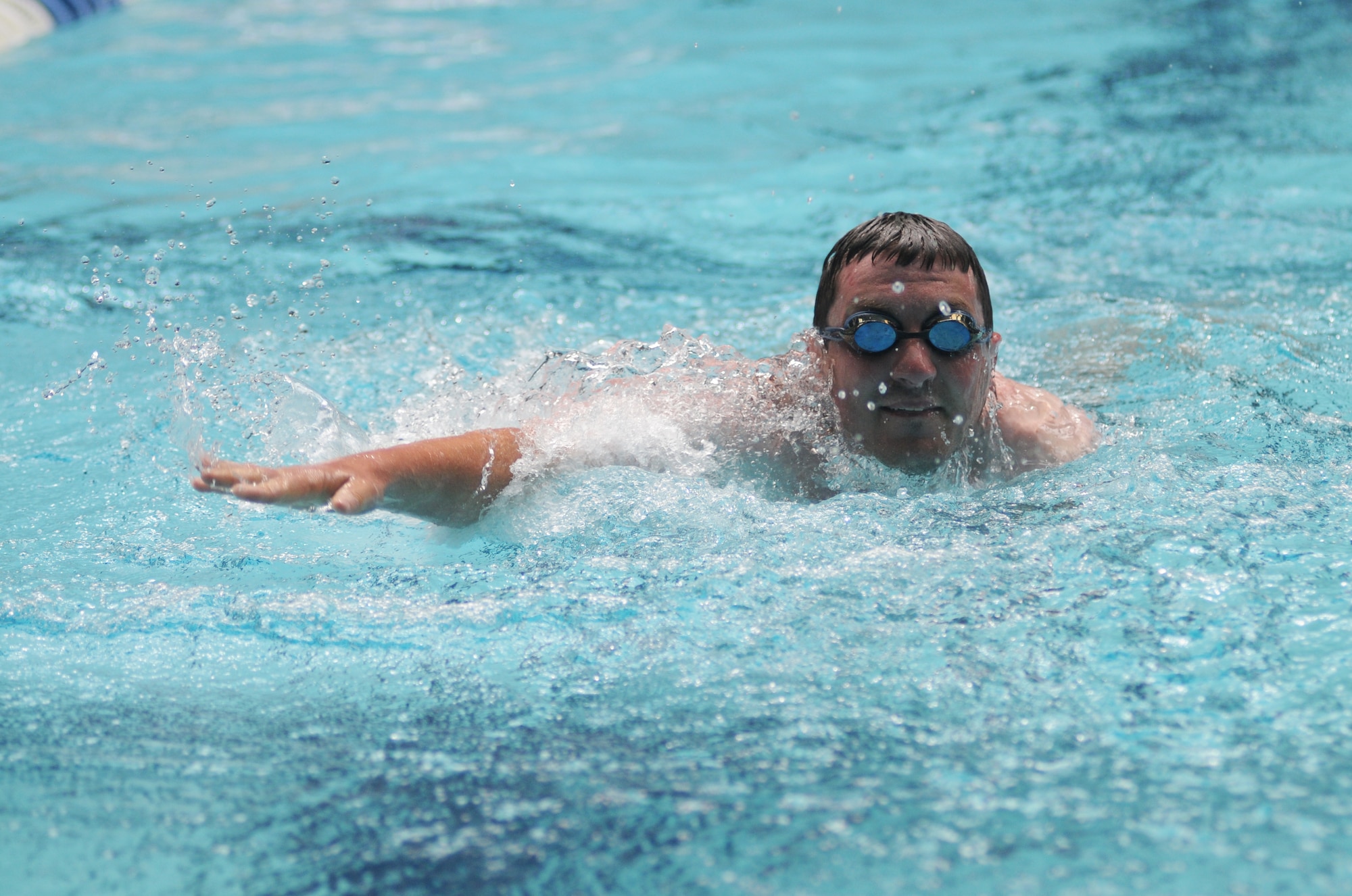 Ben Rogers, athlete, participates in the 100-meter freestyle swim competition during the Special Olympics Mississippi Summer Games May 10, 2014, at the Biloxi Natatorium, at Keesler Air Force Base, Miss.  More than 900 athletes and 3,000 volunteers worked together to hold competitions throughout the day.  This is the 28th year Keesler has hosted the state Special Olympics.  (U.S. Air Force photo by Kemberly Groue)