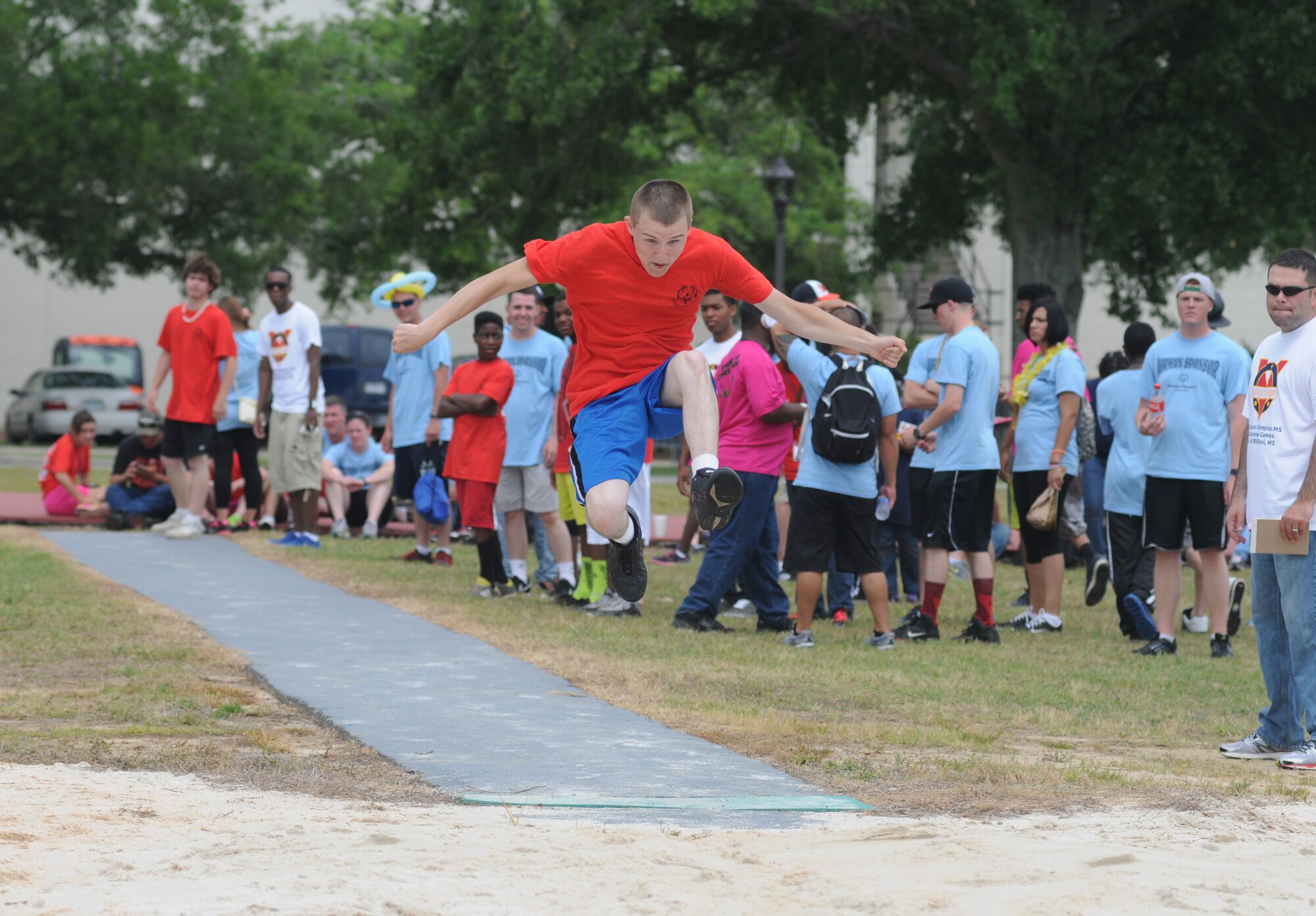 Gregory Cassatt, athlete, participates in the running long jump during the Special Olympics Mississippi Summer Games May 10, 2014, near  the triangle track, at Keesler Air Force Base, Miss.  More than 900 athletes and 3,000 volunteers worked together to hold competitions throughout the day.  This is the 28th year Keesler has hosted the state Special Olympics.  (U.S. Air Force photo by Kemberly Groue)