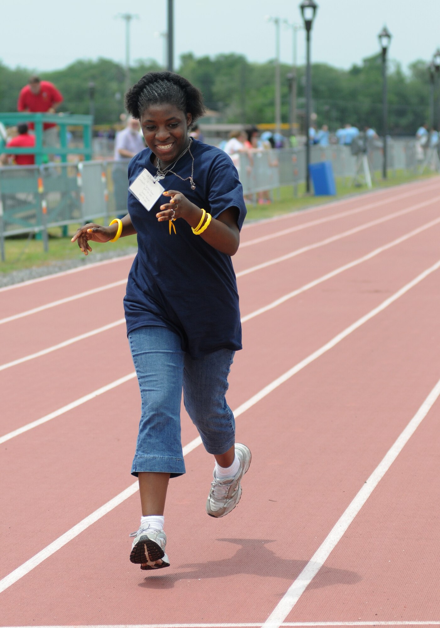 Erica Nickerson, athlete, makes her way to the finish line to take the gold in the 400-meter walk during the Special Olympics Mississippi Summer Games May 10, 2014, at the triangle track, at Keesler Air Force Base, Miss.  More than 900 athletes and 3,000 volunteers worked together to hold competitions throughout the day.  This is the 28th year Keesler has hosted the state Special Olympics.  (U.S. Air Force photo by Kemberly Groue)