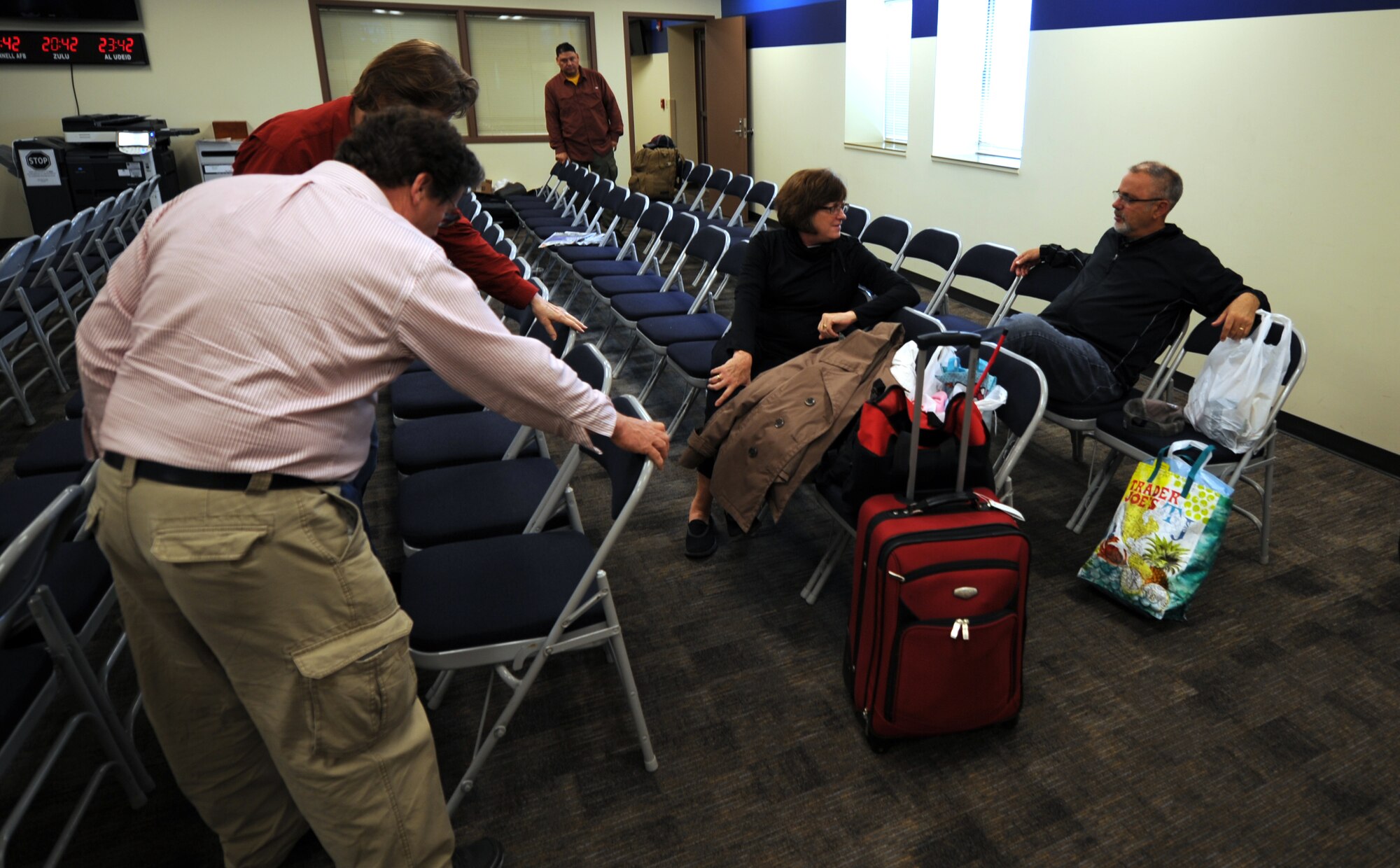 Customers  wait in the passenger terminal for a space available flight to Royal Air Force Mildenhall England, May 7, 2014, at McConnell Air Force Base, Kan. Space-A travel allows service members, accompanied spouses and retirees the opportunity to fly across the globe for free. (U.S. Air Force photo/Airman 1st Class Aaron-Forrest Wainwright)