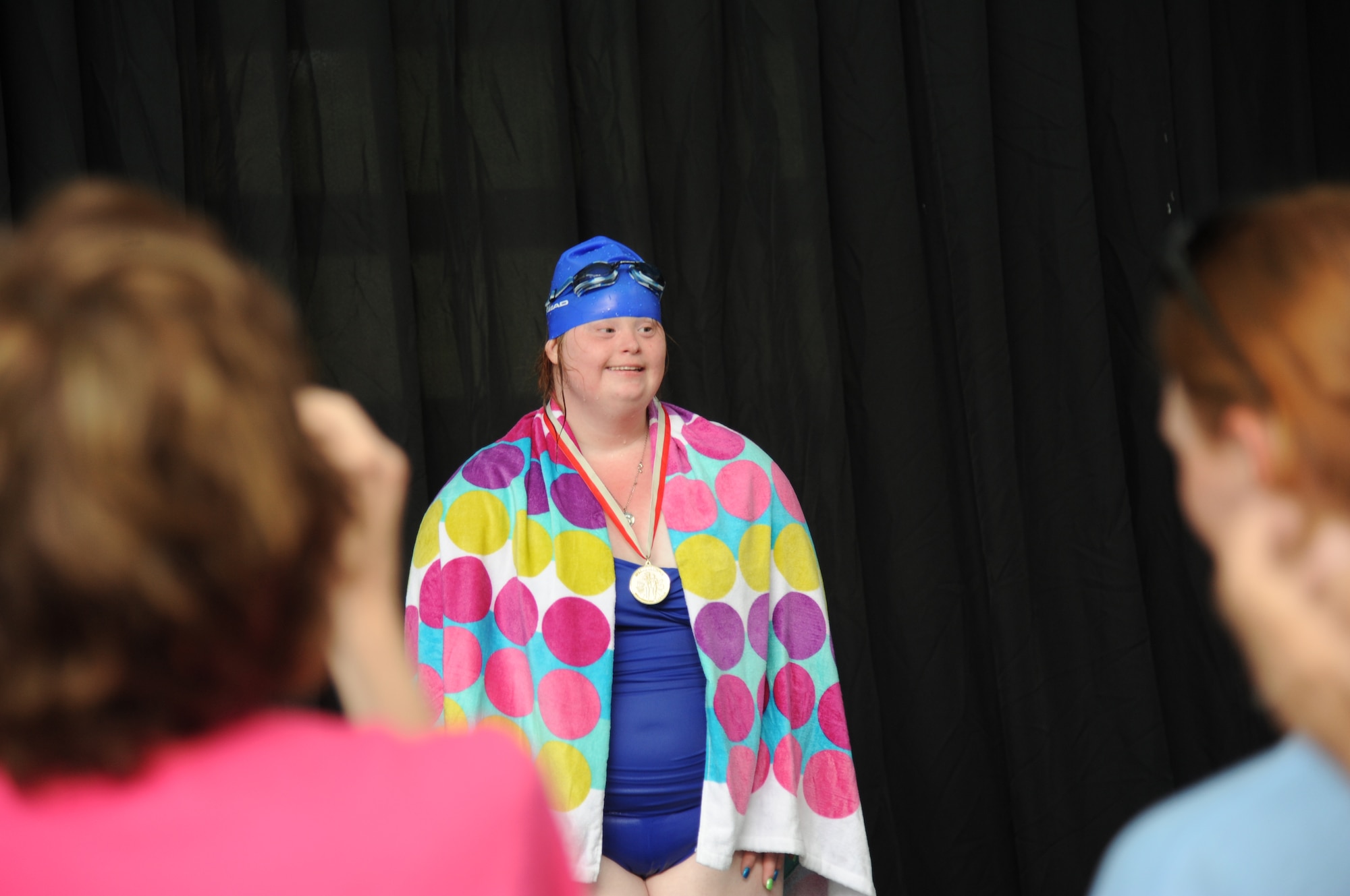 Sarah Grace Poole, athlete, is awarded the gold medal in the 15-meter swim event during the Special Olympics Mississippi Summer Games May 10, 2014, at the Biloxi natatorium, at Keesler Air Force Base, Miss.  More than 900 athletes and 3,000 volunteers worked together to hold competitions throughout the day.  This is the 28th year Keesler has hosted the state Special Olympics.  (U.S. Air Force photo by Kemberly Groue)