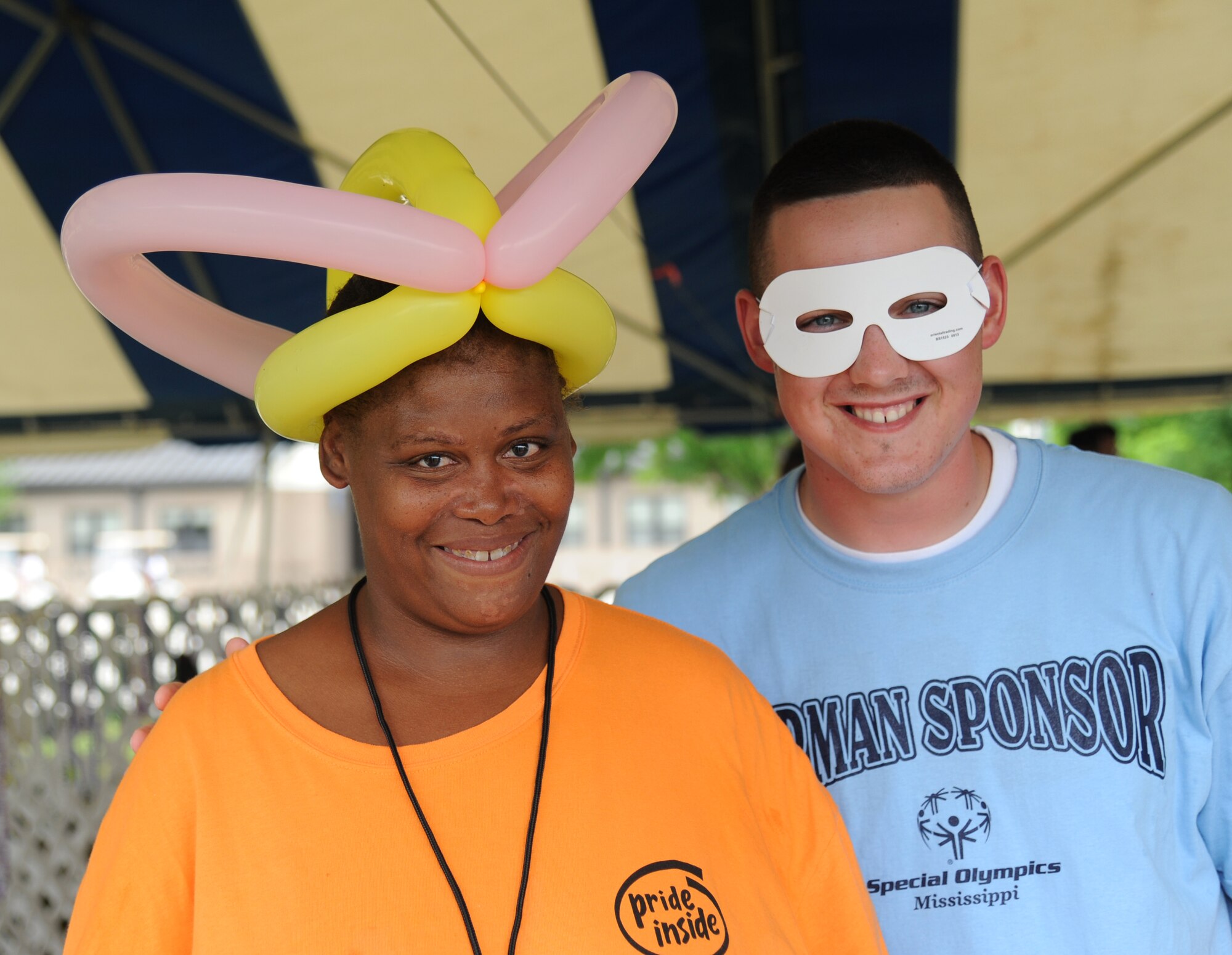 Barbara Grady, athlete, and her Airman sponsor, Airman 1st Class Jason Dasch, 338th Training Squadron, display their balloon hat and mask while visiting the Olympic Village during the Special Olympics Mississippi Summer Games May 10, 2014, at the student parade grounds, at Keesler Air Force Base, Miss.  More than 900 athletes and 3,000 volunteers worked together to hold competitions throughout the day.  This is the 28th year Keesler has hosted the state Special Olympics.  (U.S. Air Force photo by Kemberly Groue)
