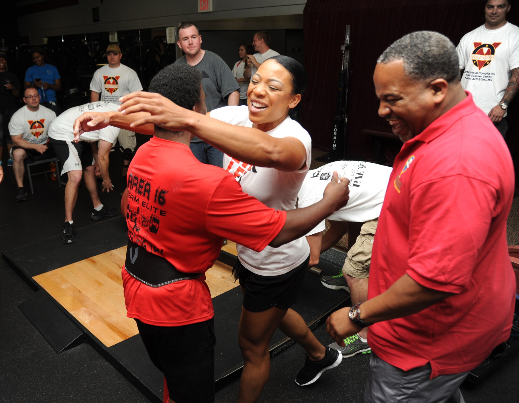 Master Sgt. Mayisha Johnson, 81st Medical Support Squadron, hugs Teddy Underwood, athlete, after he successfully completed a 358-pound dead lift during the power lifting competition at the Special Olympics Mississippi Summer Games May 10, 2014, at the Triangle Fitness Center, at Keesler Air Force Base, Miss.  More than 900 athletes and 3,000 volunteers worked together to hold competitions throughout the day.  This is the 28th year Keesler has hosted the state Special Olympics.  (U.S. Air Force photo by Kemberly Groue)