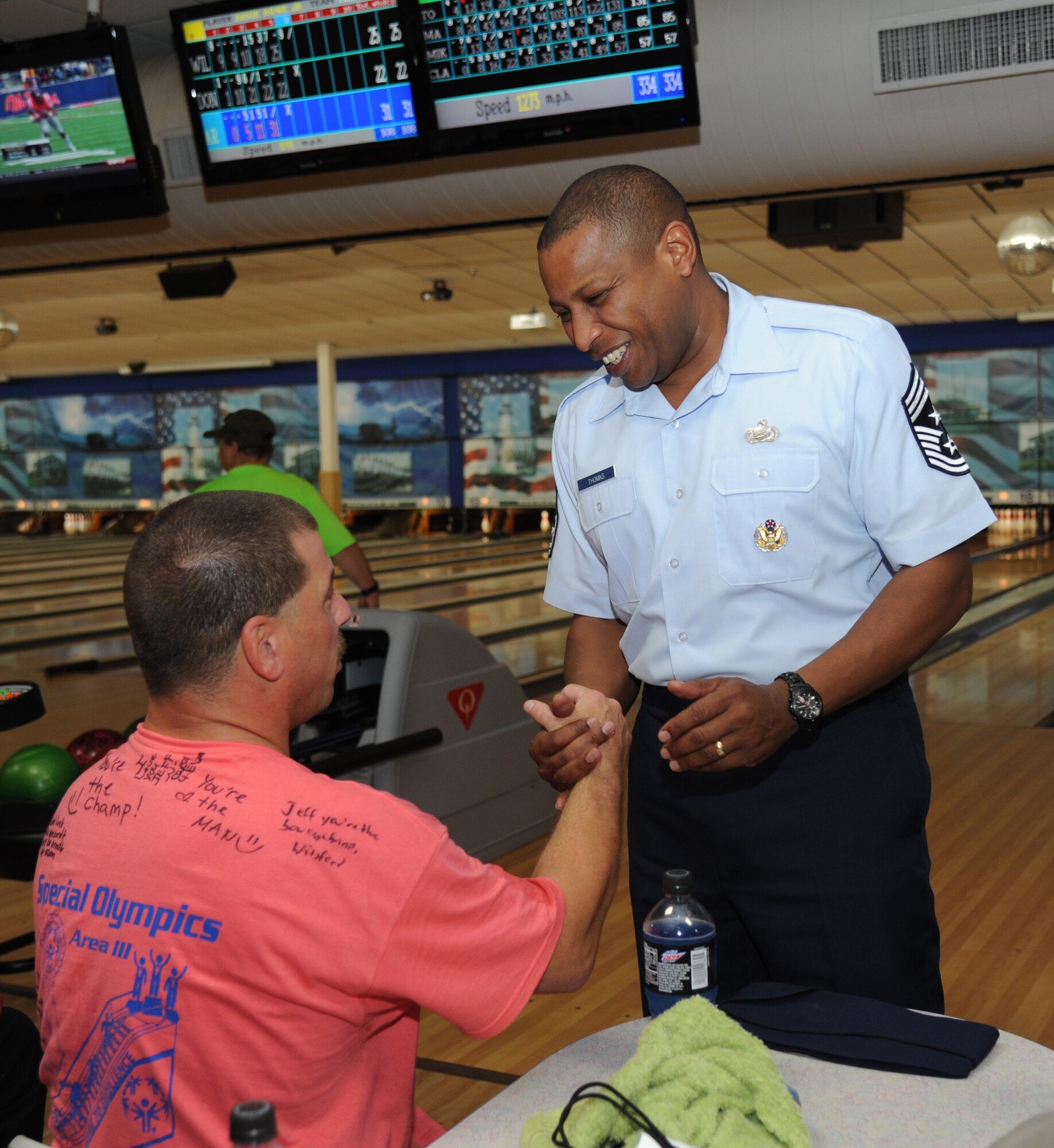 Jeff Vanarsdale, athlete, is greeted by Chief Master Sgt. Farrell Thomas, 81st Training Wing command chief, during the Special Olympics Mississippi Summer Games May 10, 2014, at Gaude Lanes, at Keesler Air Force Base, Miss.  More than 900 athletes and 3,000 volunteers worked together to hold competitions throughout the day.  This is the 28th year Keesler has hosted the state Special Olympics.  (U.S. Air Force photo by Kemberly Groue)