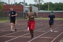 Participants run laps around Lowndes High School’s track for the Inaugural Tiger Run in Valdosta Ga., May 10, 2014. Participants ran more than 1,500 miles combined. (U.S. Air Force photo by Airman Dillian Bamman/Released)