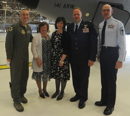 Col. Brian Newberry, his wife, Jill, and Chief Master Sgt. Lance Turner, present the Blue Star Spouse Award to Jodie Walker, spouse of Lt. Col. Marc Walker, at Fairchild Air Force Base, Wash., May 9, 2014.  Ms. Walker went above and beyond supporting Airmen and their families in her husband's squadron and providing countless hours to the Officer Spouses Club’s volunteer events and Operation Homefront toy drive. Newberry is the 92nd Air Refueling Wing commander, Turner is the 92nd ARW acting command chief, and Walker is the previous 92nd Aircraft Maintenance Squadron commander.  Anyone interested in nominating someone for the Blue Star Spouse Award should contact their squadron commander. (U.S. Air Force photo by Airman 1st Class Sam Fogleman/Released)