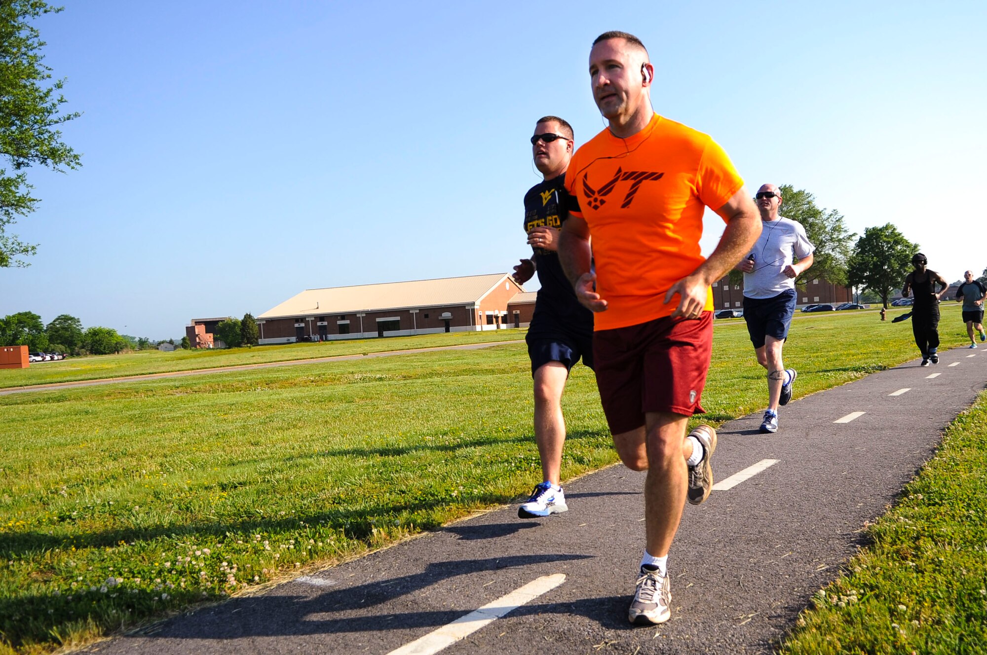 Joint Base Langley-Eustis community members jog during the National Police Week 5K run at Langley Air Force Base, Va., May 13, 2014. In 1962, President John Kennedy designated May 15 as Peace Officers Memorial Day and dubbed the week of May 15 as NPW. (U.S. Air Force photo by Senior Airman Austin Harvill/Released)