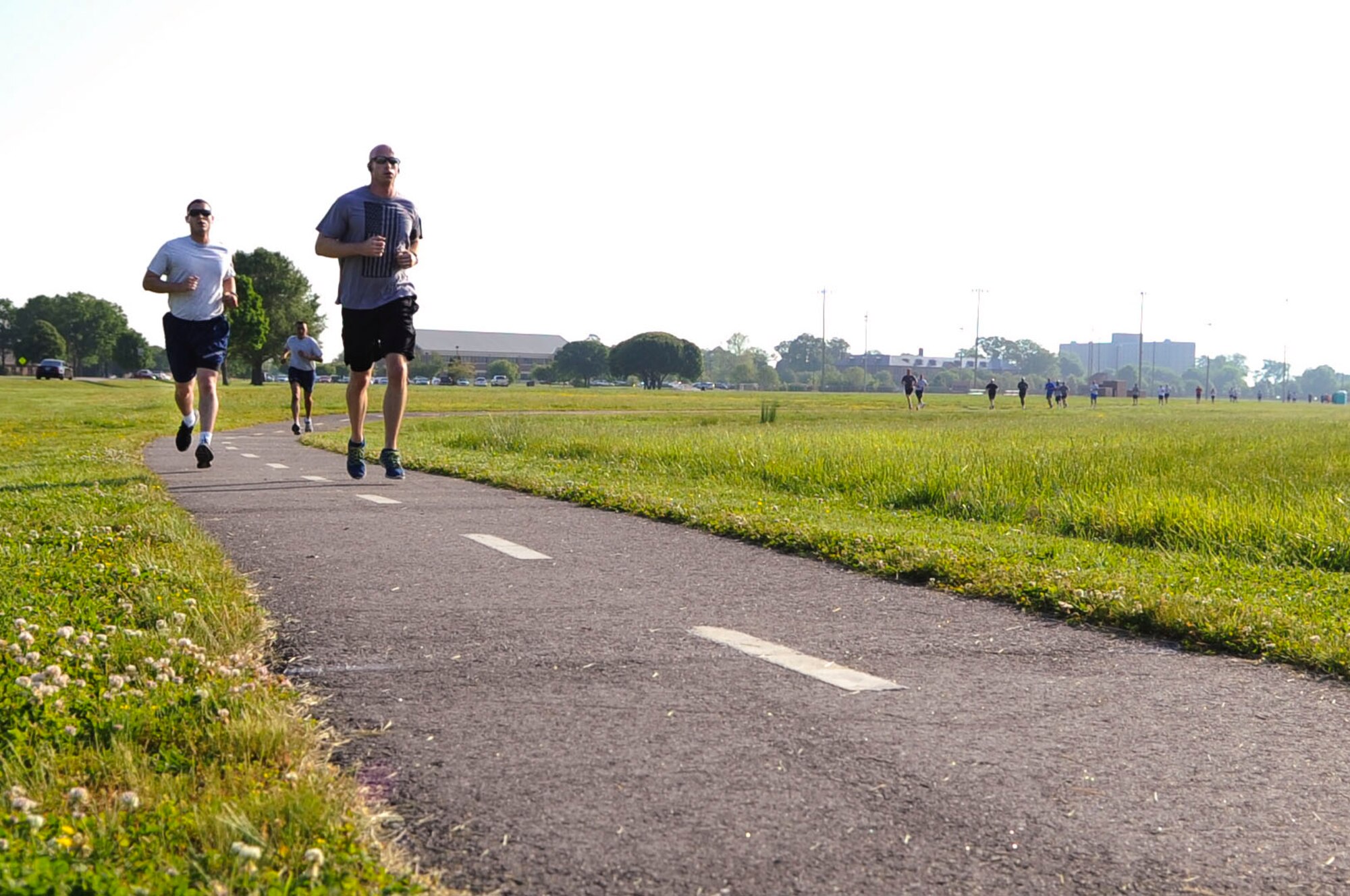 Joint Base Langley-Eustis community members run toward a checkpoint during the National Police Week 5K run at Langley Air Force Base, Va., May 13, 2014. NPW honors both military and civilian law enforcement officials across the nation through events like the 5K. (U.S. Air Force photo by Senior Airman Austin Harvill/Released) (photo cropped, contrasted, color corrected, dodged, burned and sharpened for effect)