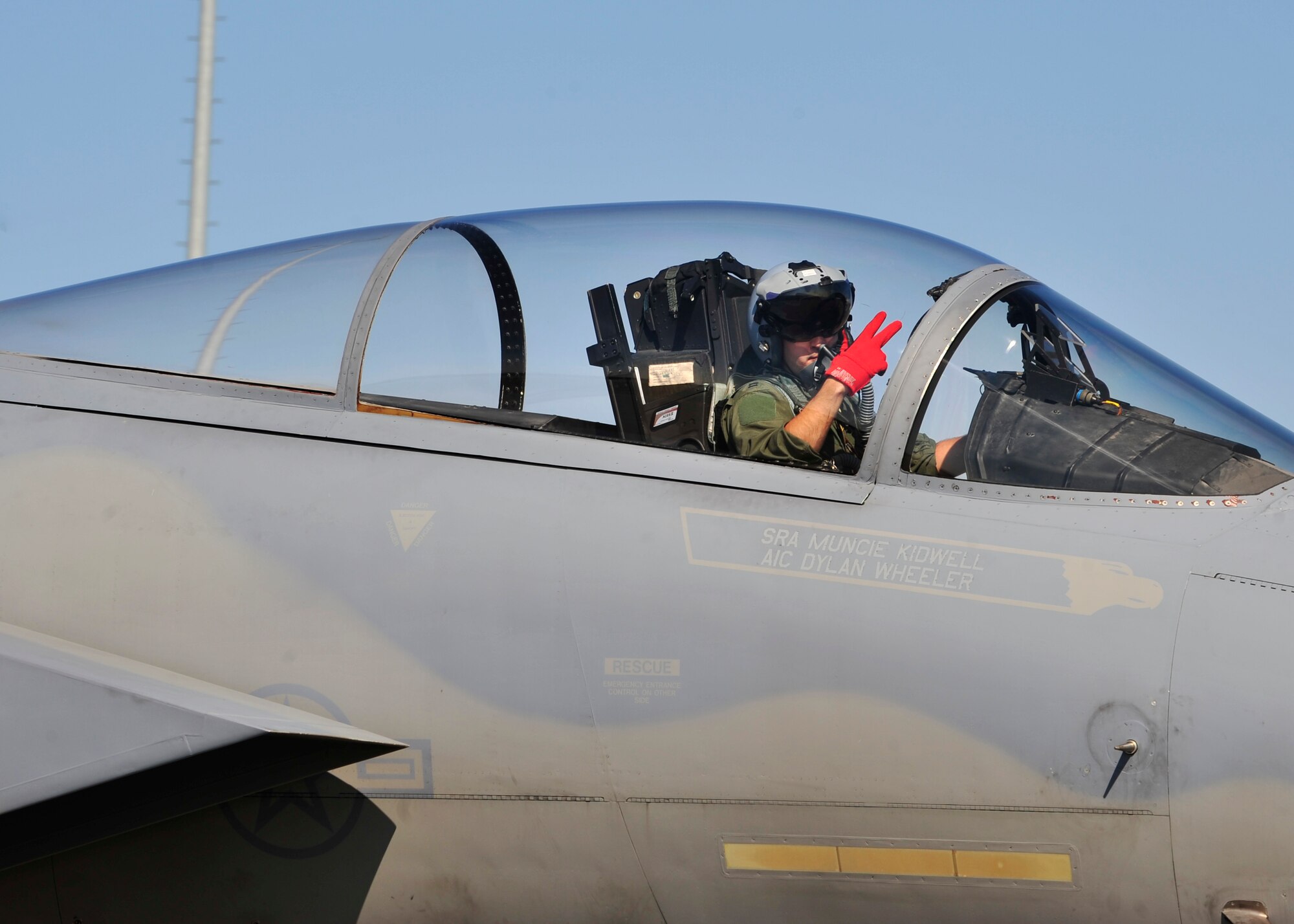 A U.S. Air Force F-15 Eagle assigned to the 67th Fighter Squadron, Kadena Air Base, Japan, waves as he taxis on the runway May 12, 2014, Eielson Air Force Base, Alaska. Different units from around the world gathered together to participate in RED FLAG-Alaska 14-1, a two week-long air combat exercise. (U.S. Air Force photo by Senior Airman Ashley Nicole Taylor/Released)