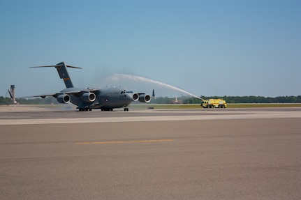 Lt. Col. Stewart Newton,16th Airlift Squadron commander, taxis a C-17 past Joint Base Charleston fire trucks at the conclusion of his “Fini” flight, May 8, 2014, at JB Charleston, S.C. Newton will be moving just up the road to Columbia, S.C., where he will assume the duties as the University of South Carolina Reserve Officer Training Corps commander. (U.S. Air Force photo/ 1st Lt. Mark Benischek)