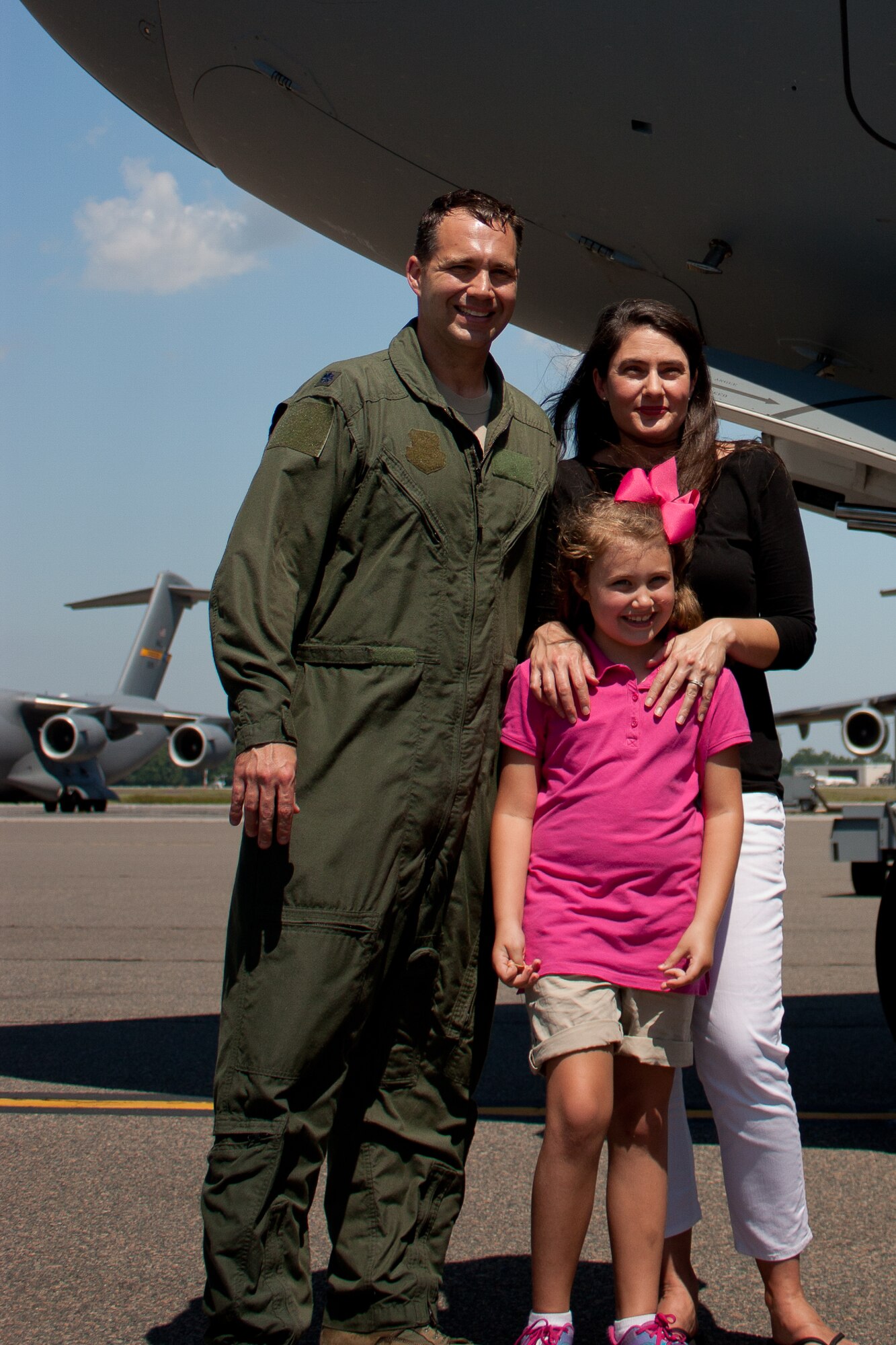 Lt. Col. Stewart Newton, 16th Airlift Squadron commander, poses with his wife Carey and daughter Rachel, after Newton completed his “Fini Flight" May 8,  2014, at Joint Base Charleston, S.C. Newton will be moving just up the road to Columbia, S.C., where he will assume the duties as the University of South Carolina Reserve Officer Training Corps commander.  (U.S. Air Force photo/ 1st Lt. Mark Benischek)

