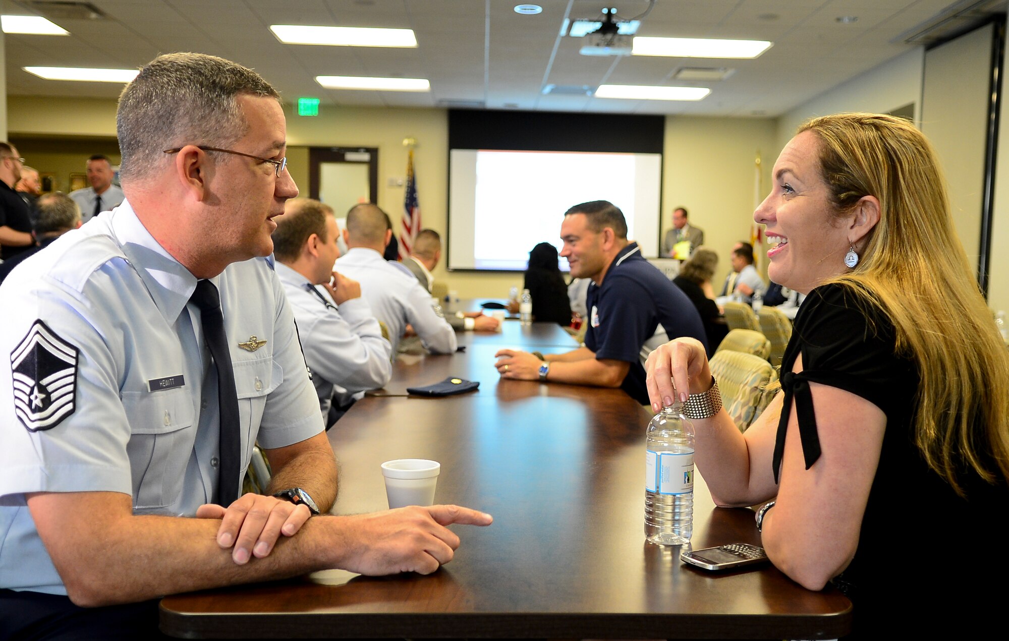 Senior Master Sgt. Henry Hewitt, 310th Airlift Squadron operations superintendent, and Peggy Steele, Tampa Electric Company manager of recruitment and staffing, talk during the meet-and-greet portion of Operation Partnership day two at the Greater Tampa Chamber of Commerce, May 8, 2014. Day two of OP allowed service members the opportunity to work in the civilian work force for a day. (U.S. Air Force photo by Airman 1st Class Ned T. Johnston/Released)