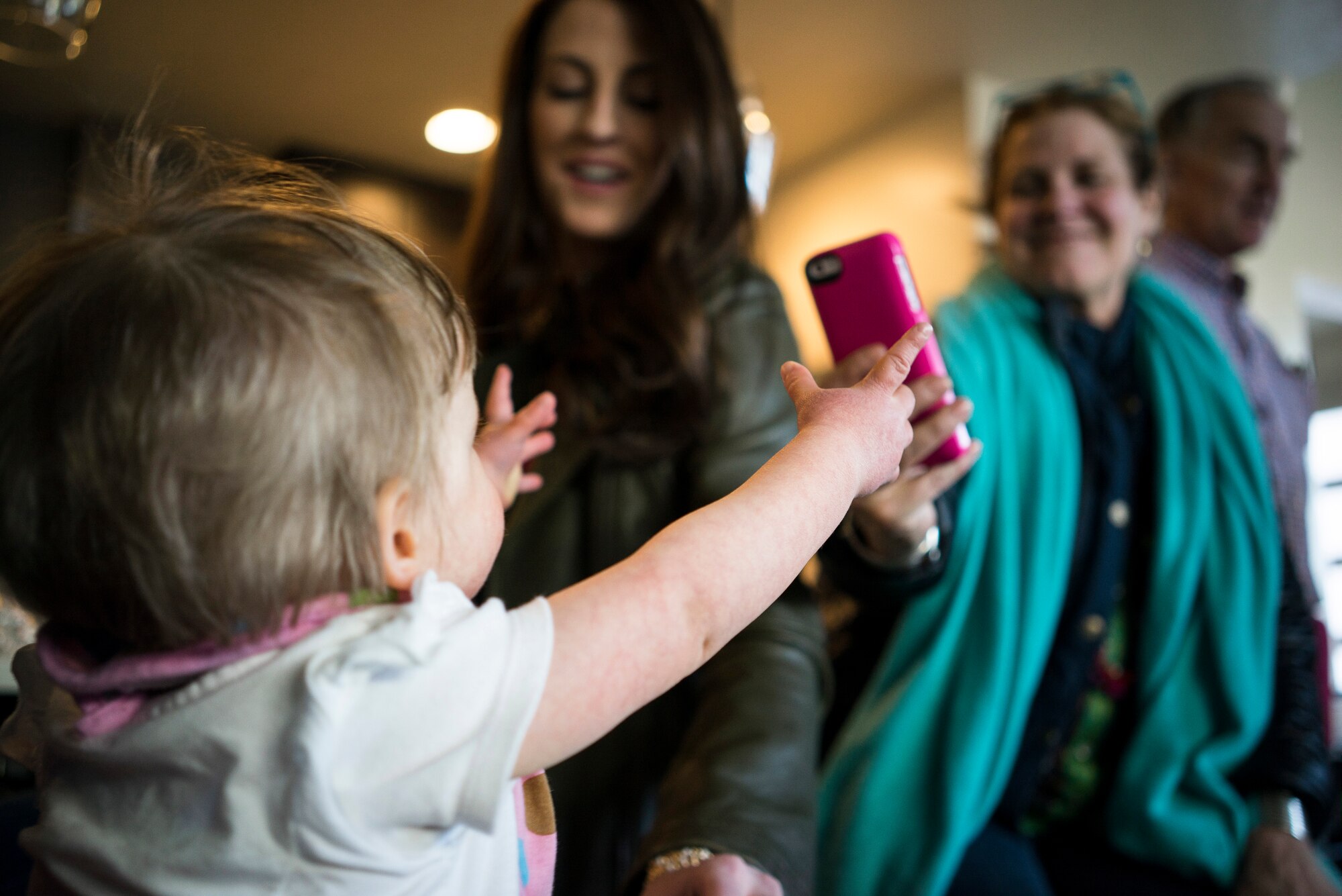 Oleksandra Valley raises her arms for attention as her photo is taken at a friend's house in Boise, Idaho. Mark Tschampl, a long-time friend of the Valleys, and his wife, Capt. Lauren Tschampl, threw a welcome home party for Oleksandra. (U.S. Air Force photo/Tech. Sgt. Samuel Morse)