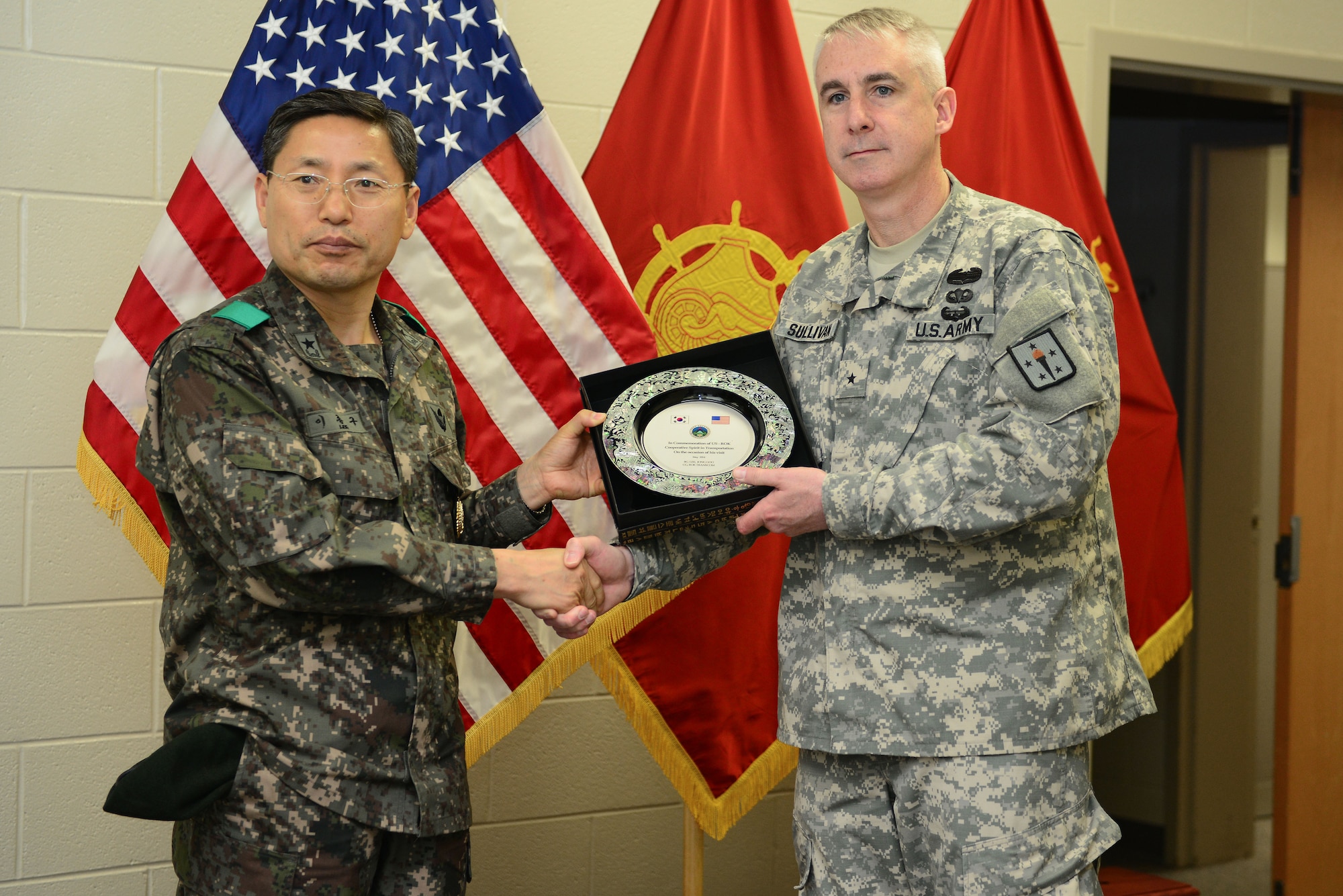 From left, Republic of Korea Brig. Gen. Jong Goo Lee, Republic of Korea Transportation Command commander, and U.S. Army Brig. Gen. John P. Sullivan, U.S. Army Transportation Corps chief of transportation, pose for a photo at Fort Eustis, Va., May 13, 2014. Lee visited the Simulation Center as part of his tour of the Transportation Corps' maritime training capabilities. (U.S. Air Force photo by Airman 1st Class Kimberly Nagle/Released)