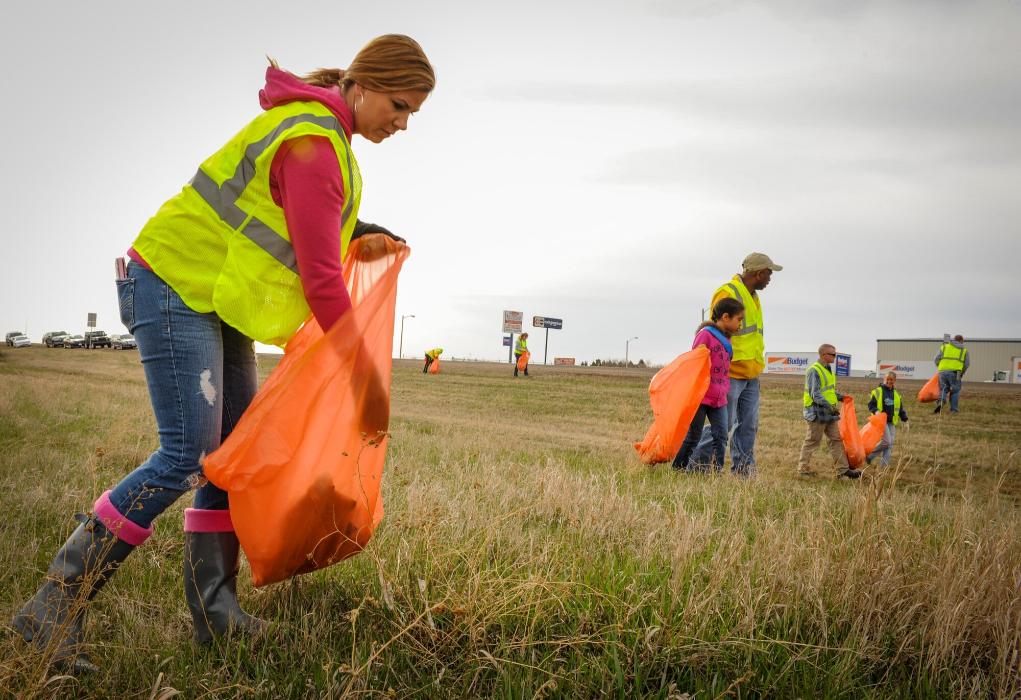 Master Sgt. Melissa Bembnowski, 5th Operations Support Squadron health aviation resource management chief, assists with trash cleanup along the highway 83 bypass in Minot N.D., May 10, 2014. Bembnowski is part of chapter 959 of the Air Force Sergeants Association and her group is responsible for maintaining a section of the bypass near the Hyatt House hotel. (U.S. Air Force photo/Senior Airman Stephanie Sauberan)