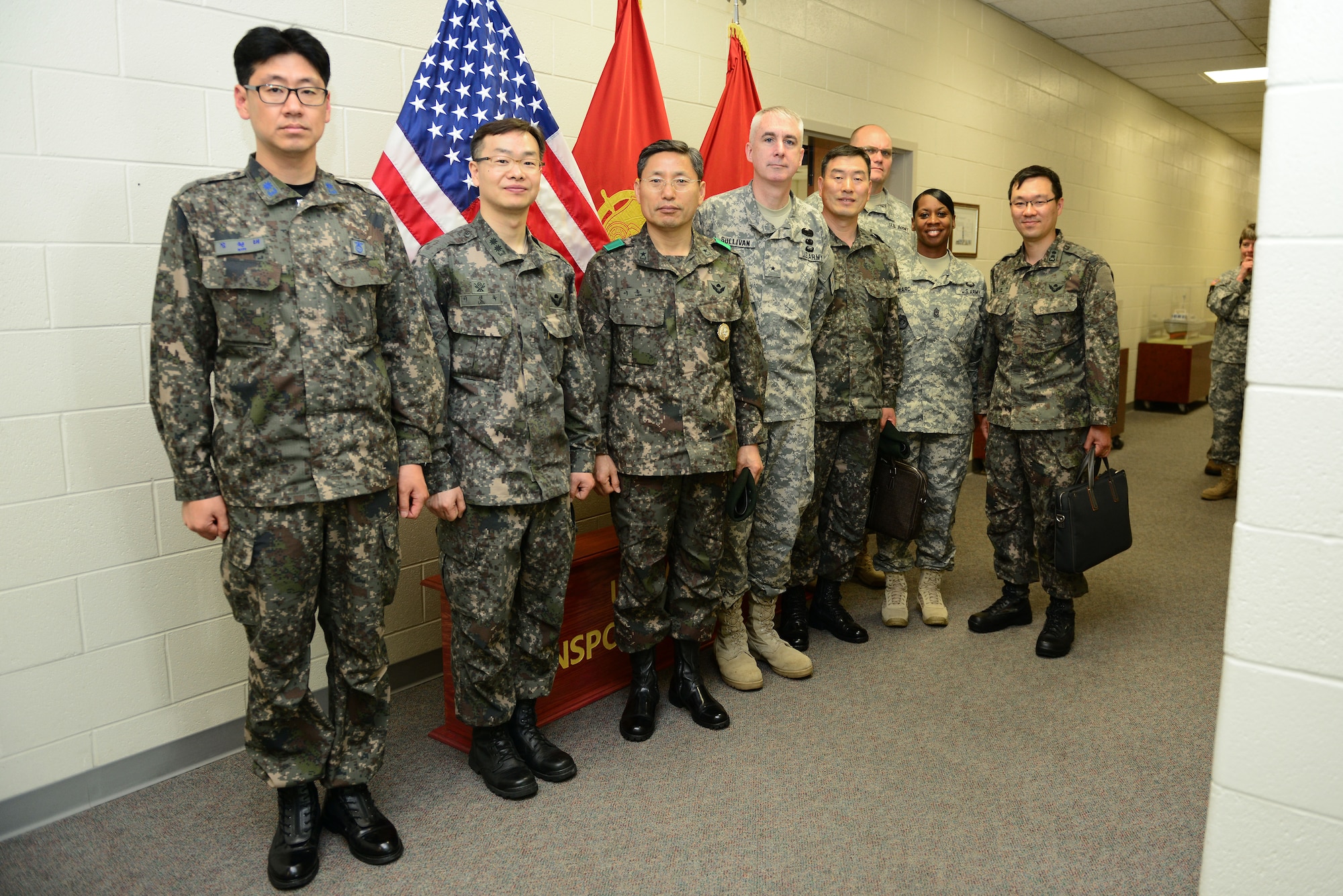 Fourth from left, U.S. Army Brig. Gen. John P. Sullivan, U.S. Army Transportation Corps chief of transportation, hosted Republic of Korea Transportation Command commander, Brig. Gen. Jong Goo Lee, third from left, at the Simulation Center at Fort Eustis, Va., May 13, 2014. Lee and his team of transportation officers had the opportunity to test a few of the center’s training simulators during their tour of the Transportation Corps' maritime training capabilities. (U.S. Air Force photo by Airman 1st Class Kimberly Nagle/Released)