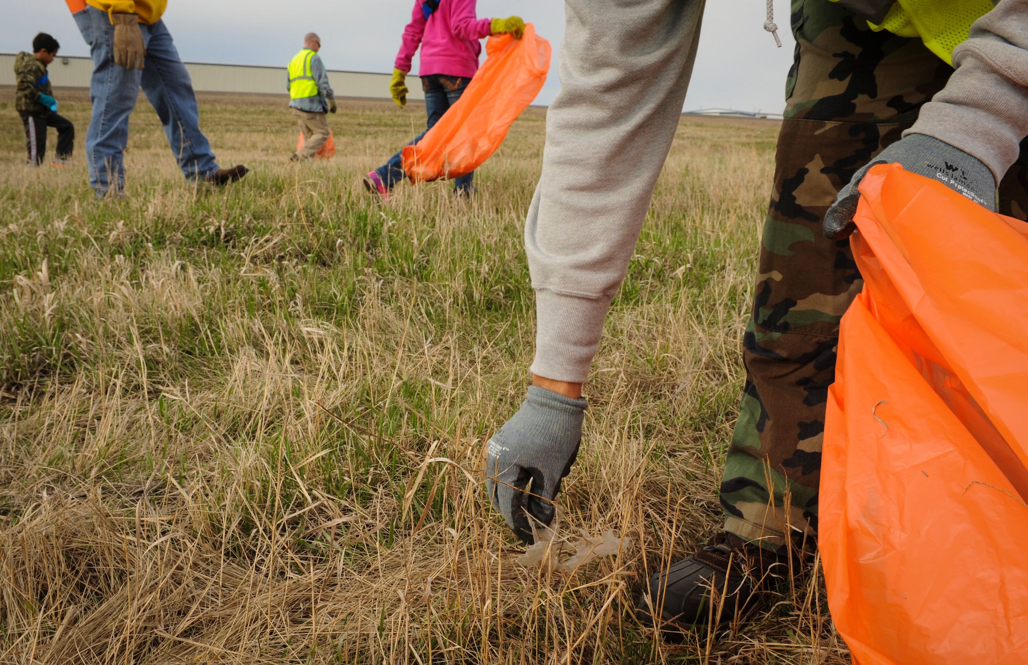 A member of the Air Force Sergeants Association, chapter 959, picks up trash along the highway 83 bypass in Minot N.D., May 10, 2014. Members of chapter 959 met at 9 a.m. to begin clean up. There group is responsible for maintaining a section of the bypass near the Hyatt House hotel. (U.S. Air Force photo/Senior Airman Stephanie Sauberan)