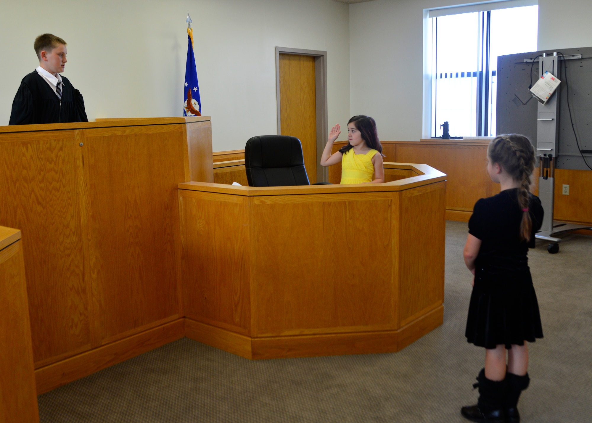 Vincent Bonavita portrays a judge and swears in Joey Fleegal as she portrays Goldilocks’s mom in a mock trial of Goldilocks and the Three Bears May 2, 2014, at Dover Air Force Base, Del. Children from the youth center participated in a mock trial and learned about how the legal system works. (U.S. Air Force photo/Airman 1st Class William Johnson)