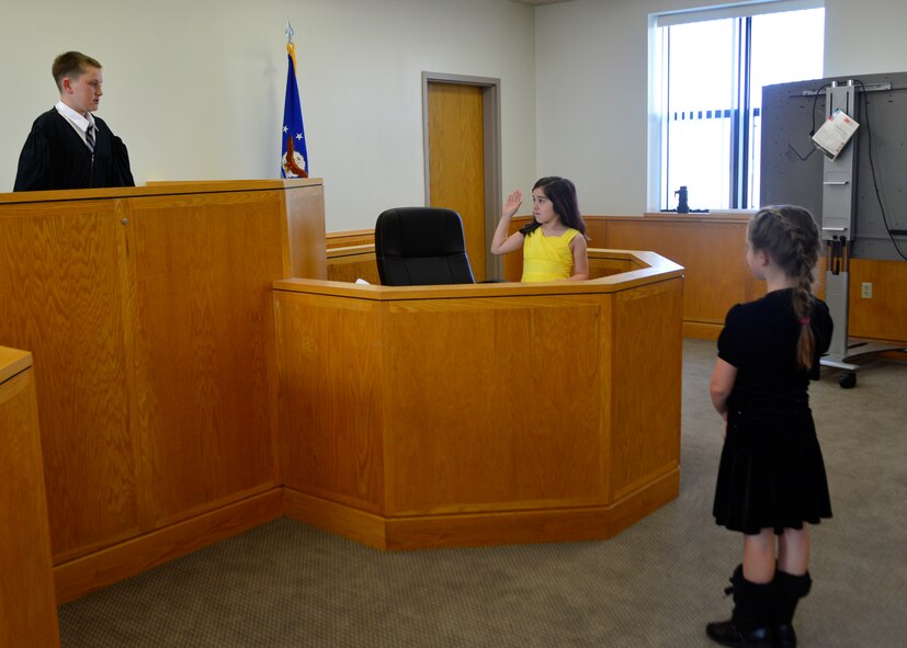Vincent Bonavita portrays a judge and swears in Joey Fleegal as she portrays Goldilocks’s mom in a mock trial of Goldilocks and the Three Bears May 2, 2014, at Dover Air Force Base, Del. Children from the youth center participated in a mock trial and learned about how the legal system works. (U.S. Air Force photo/Airman 1st Class William Johnson)