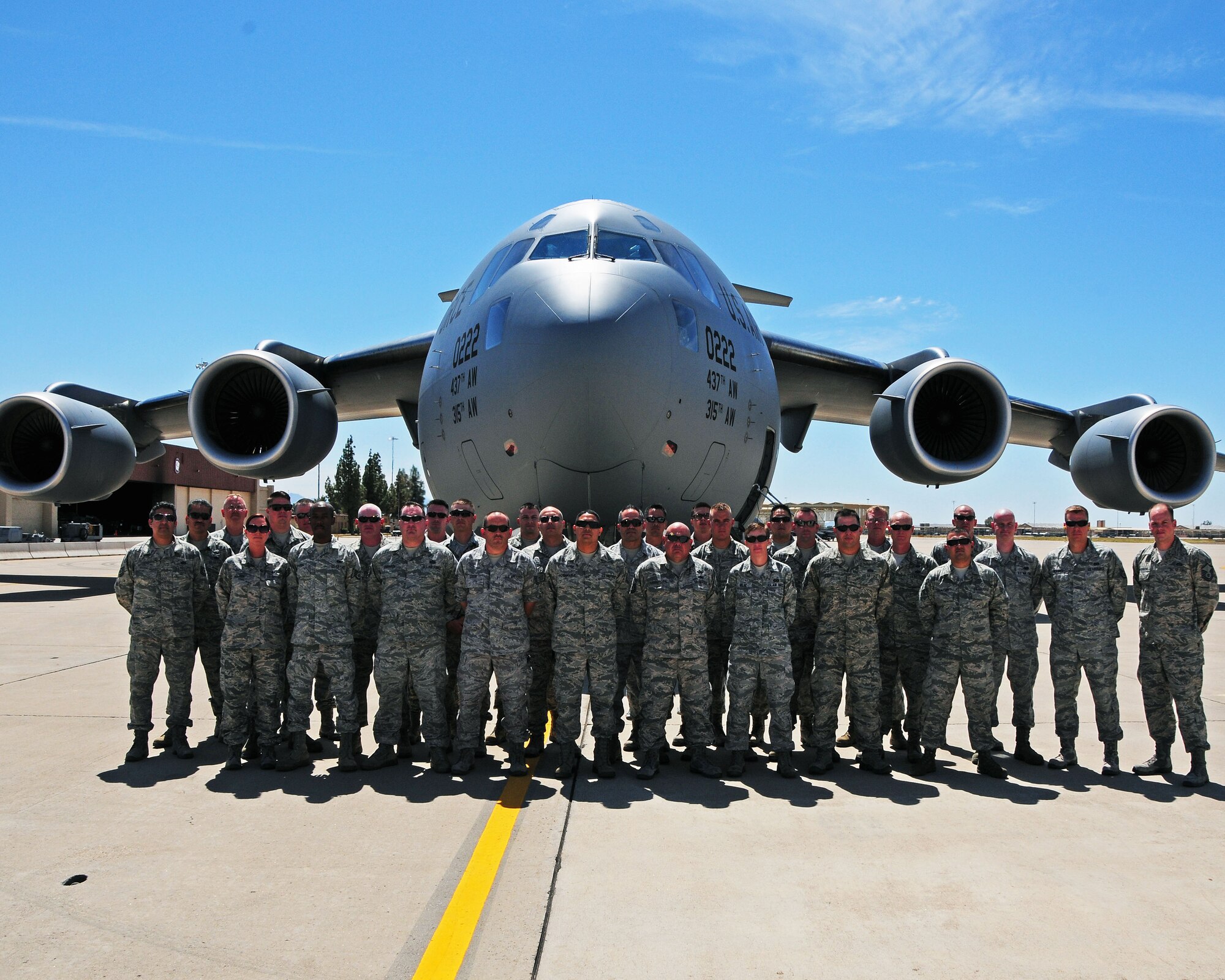 944th Fighter Wing Airmen pose for a photo at Luke Air Force Base, Ariz. before boarding a KC-17 enroute to Hickam Air Force Base, Hawaii for their temporary duty at Bellows Air Station. The trip was in support of the 944th Civil Engineer Squadron’s Innovative Readiness Training project and annual tour. (U.S. Air Force photo/Tech. Sgt. Louis Vega Jr.)