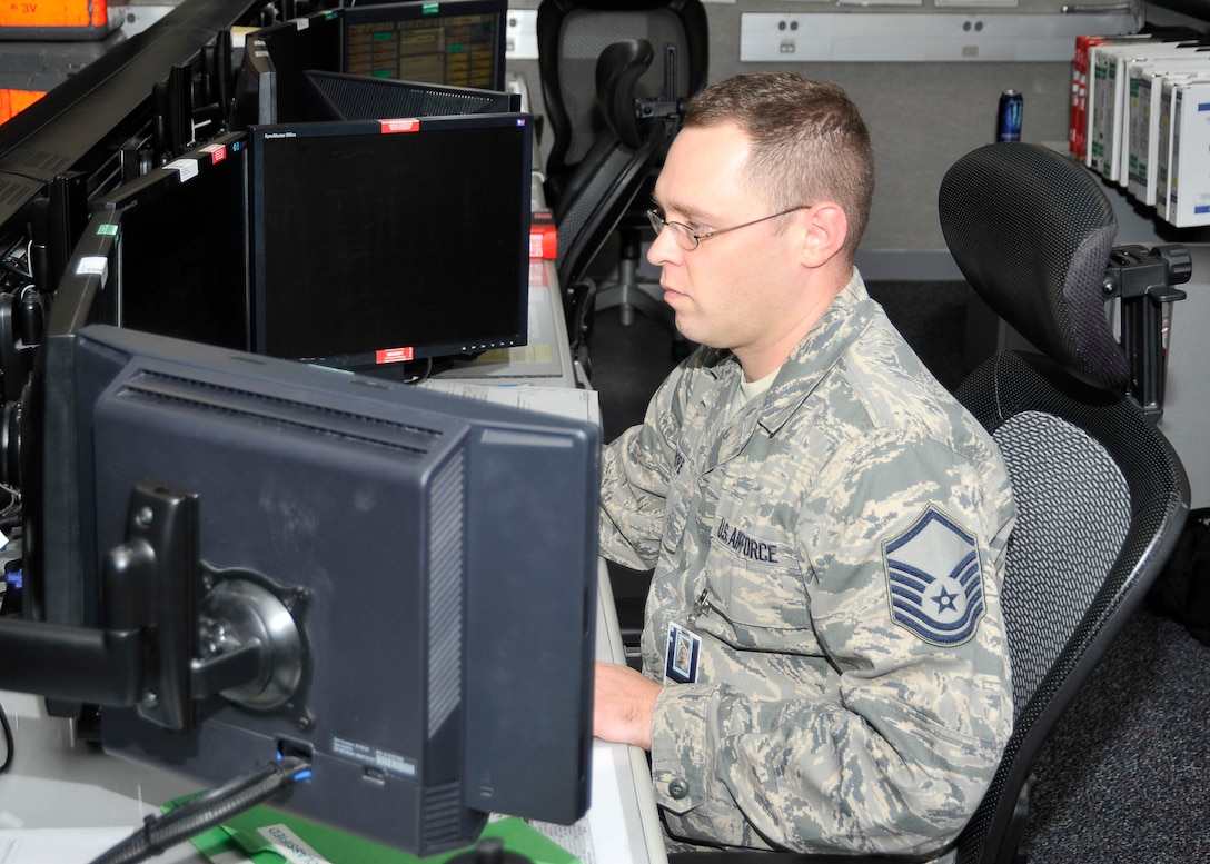 Master Sgt. Michael D. Pope, Air Forces Northern-Tyndall Command Center NCO in charge of Command Center Operations, monitors situations at his terminal May 13 at the Command Post. Airmen at the Command Post are the eyes and ears of situations that may arise on Tyndall. (U.S. Air Force photo by Solomon Cook)