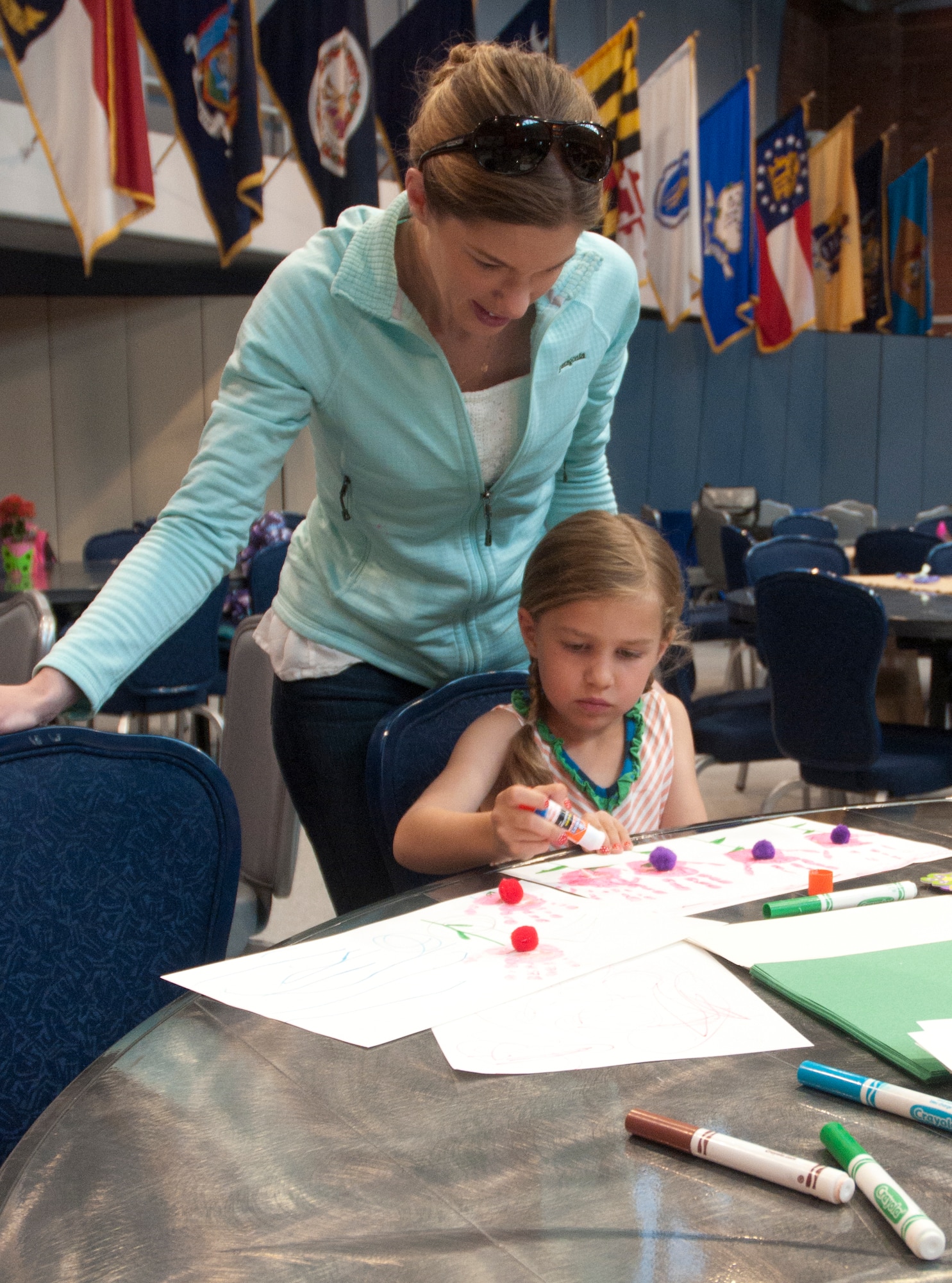 Capt. Carly Clark watches her daughter, Rory, 5, make her a Mother’s Day gift May 10 during the Mommy and Me Tea and Craft event in the Fall Hall Community Center. Clark is visiting from the Aerospace Data Facility out of Buckley Air Force Base, Colo. (U.S. Air Force photo by Airman Malcolm Mayfield)