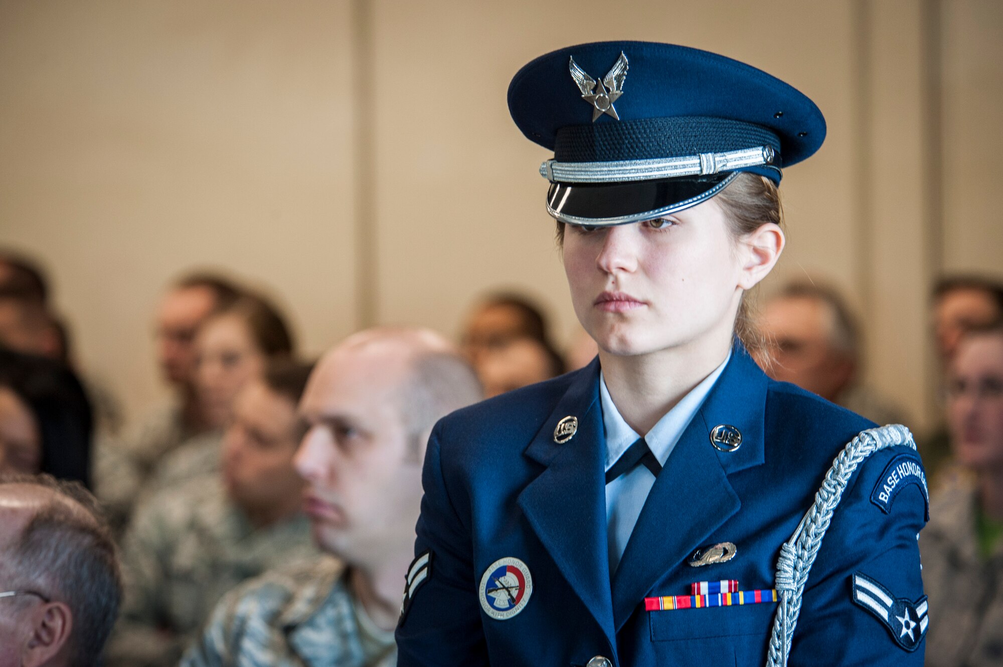 Airman 1st Class Naomi Haney stands guard during an honor guard graduation ceremony in the Red Morgan Event Center at Fairchild Air Force Base, Wash., May 9, 2014. Fairchild’s honor guard performs military honors for various events and ceremonies across the Inland Northwest every week as the installation’s front-line ambassadors. Each member from nearly every career field serves a four month rotation. Haney trained the new class of honor guard members and is a 92nd Contracting Squadron member. (U.S. Air Force photo by Staff Sgt. Benjamin W. Stratton/Released)