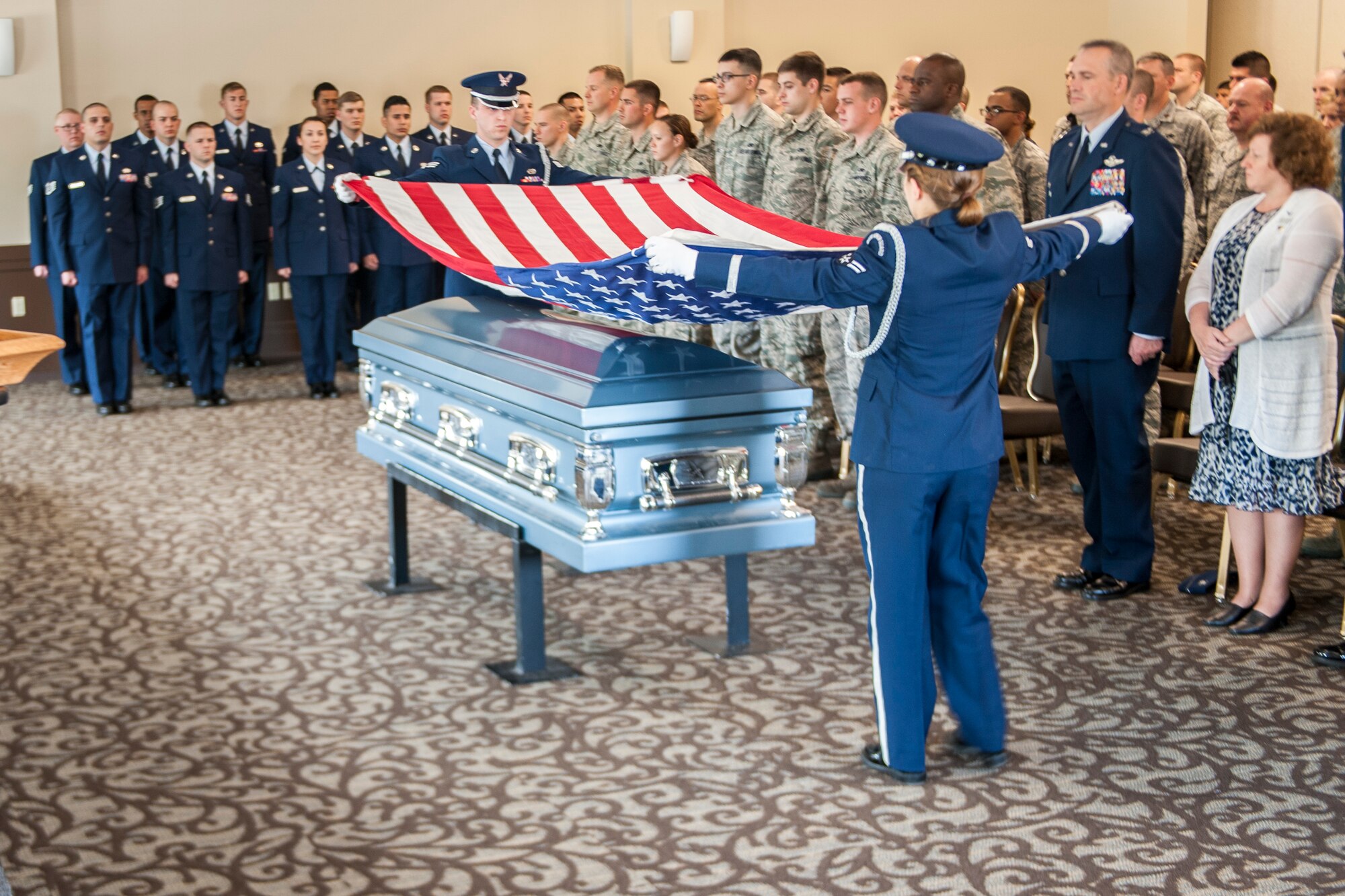 Fairchild Honor Guard trainers perform a military funeral presentation during an honor guard graduation ceremony in the Red Morgan Event Center at Fairchild Air Force Base, Wash., May 9, 2014. Fairchild’s honor guard performs military honors for various events and ceremonies across the Inland Northwest every week as the installation’s front-line ambassadors. Each member from nearly every career field serves a four month rotation. (U.S. Air Force photo by Staff Sgt. Benjamin W. Stratton/Released)