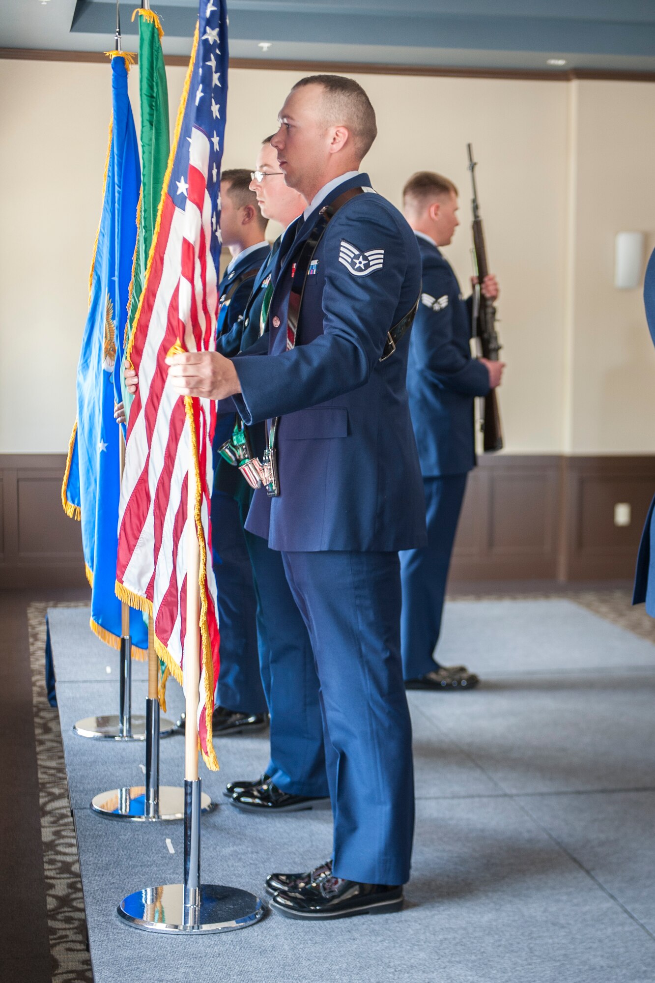 Fairchild Honor Guard graduates performing color guard duty present the colors as part of a military funeral presentation during their graduation ceremony in the Red Morgan Event Center at Fairchild Air Force Base, Wash., May 9, 2014. Fairchild’s honor guard performs military honors for various events and ceremonies across the Inland Northwest every week as the installation’s front-line ambassadors. Each member from nearly every career field serves a four month rotation. (U.S. Air Force photo by Staff Sgt. Benjamin W. Stratton/Released)