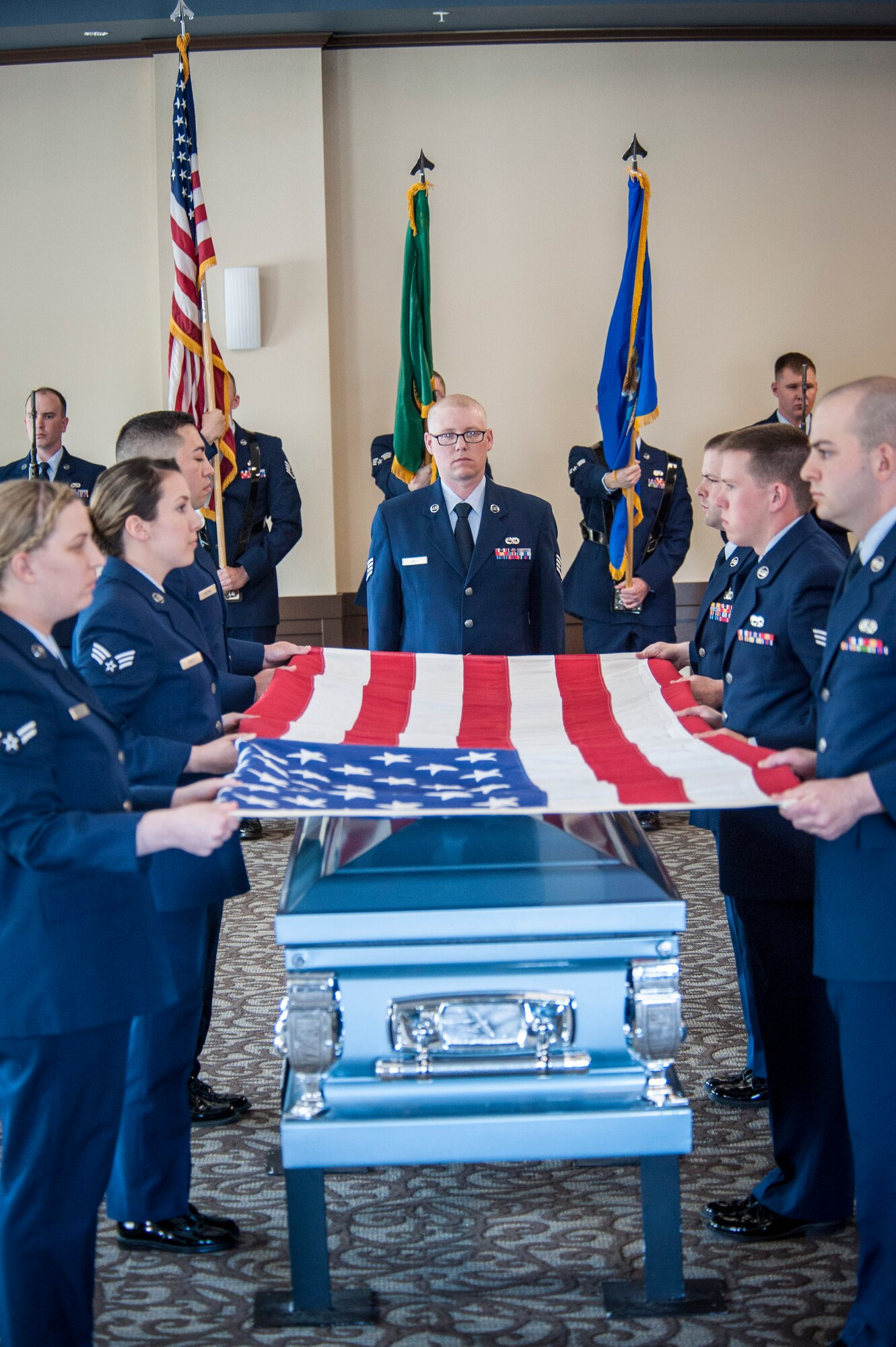 Fairchild Honor Guard graduates perform a military funeral presentation during their graduation ceremony in the Red Morgan Event Center at Fairchild Air Force Base, Wash., May 9, 2014. Fairchild’s honor guard performs military honors for various events and ceremonies across the Inland Northwest every week as the installation’s front-line ambassadors. Each member from nearly every career field serves a four month rotation. (U.S. Air Force photo by Staff Sgt. Benjamin W. Stratton/Released)