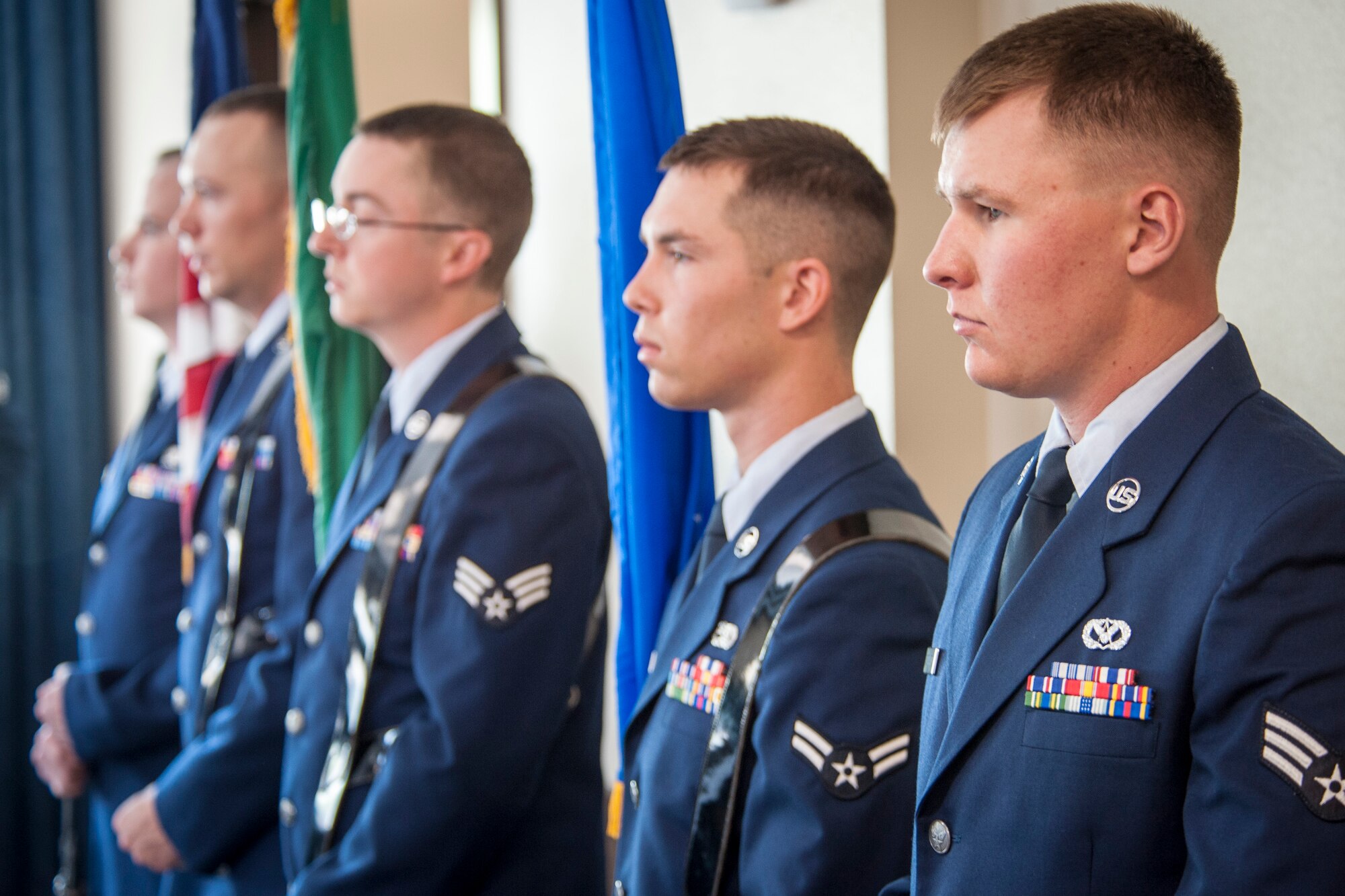 Fairchild Honor Guard graduates performing color guard duty await their cue at the beginning of their graduation ceremony in the Red Morgan Event Center at Fairchild Air Force Base, Wash., May 9, 2014. Fairchild’s honor guard performs military honors for various events and ceremonies across the Inland Northwest every week as the installation’s front-line ambassadors. Each member from nearly every career field serves a four month rotation. (U.S. Air Force photo by Staff Sgt. Benjamin W. Stratton/Released)