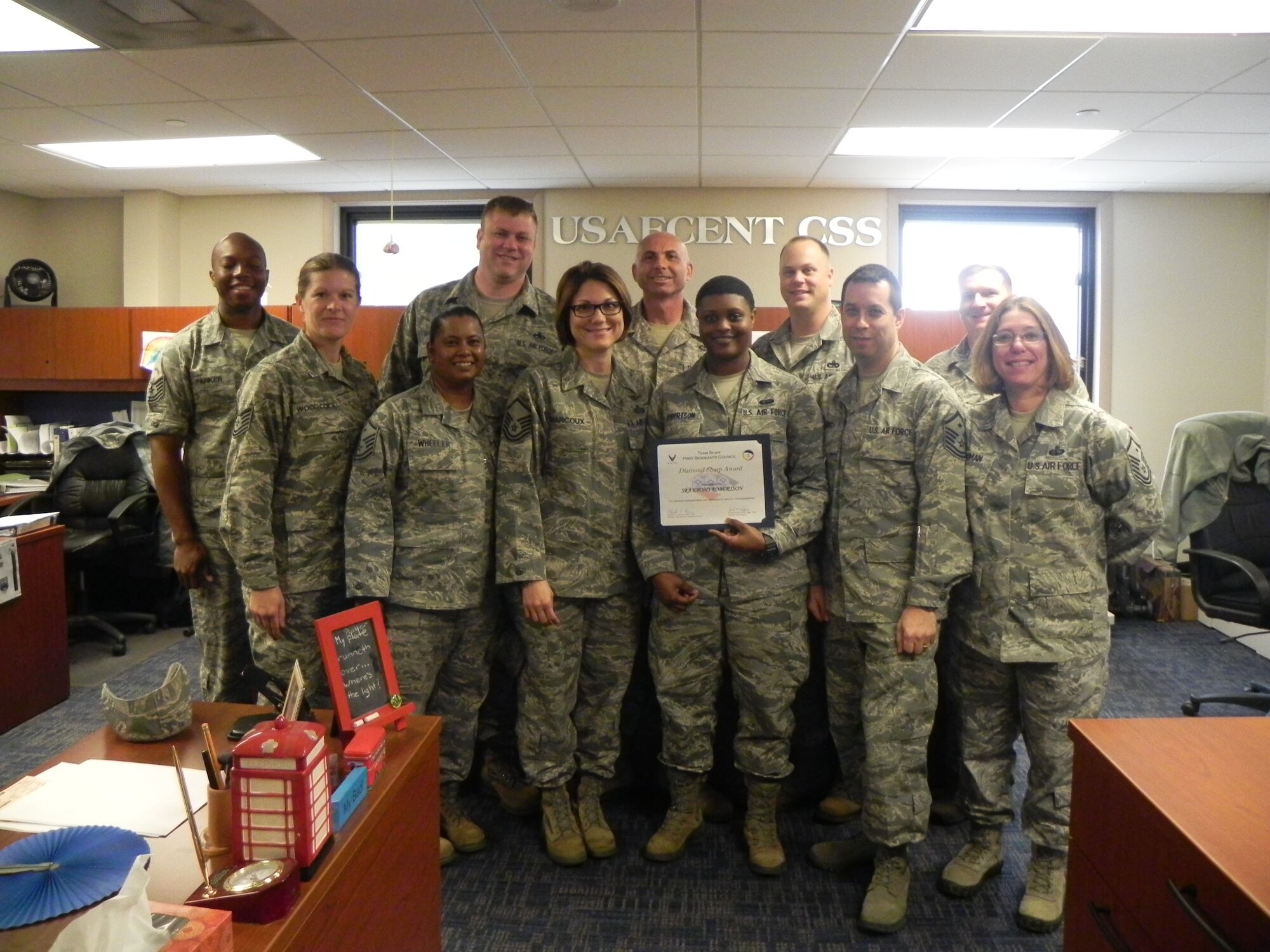 Senior Airman Ebony Robertson, U.S. Air Forces Central administrator executive, is recognized by members of the Shaw First Sergeants Council as an April "Diamond Sharp," recipient. Diamond Sharp, the First Sergeant Council’s newly adopted program, aims to recognize two Airmen from across Shaw Air Force base monthly. (Courtesy photo)