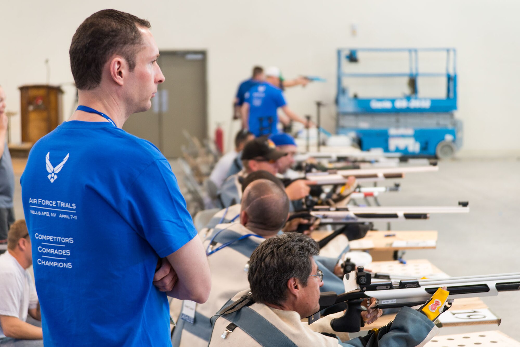 U.S. Air Force Special Agent Robert Davis, Office of Special Investigations Detachment 212 commander, watches a preliminary round of shooting events for the inaugural Air Force Wounded Warrior Trials at Nellis Air Force Base, Nev., April 2014. Davis volunteered to coach the shooting events for the Warrior Games which takes place September 28 through October 4. (Courtesy Photo/Released)