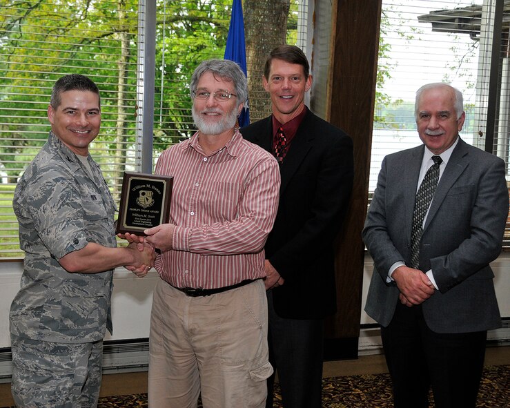 Mike Scott (second from left) receives the William M. Dunne People's Choice Award from AEDC Commander Col. Raymond Toth. Also shown in the photo is (left to right) AEDC Exective Director Dr. Douglas Blake and ATA General Manager Steve Pearson. (Photo by Rick Goodfriend)