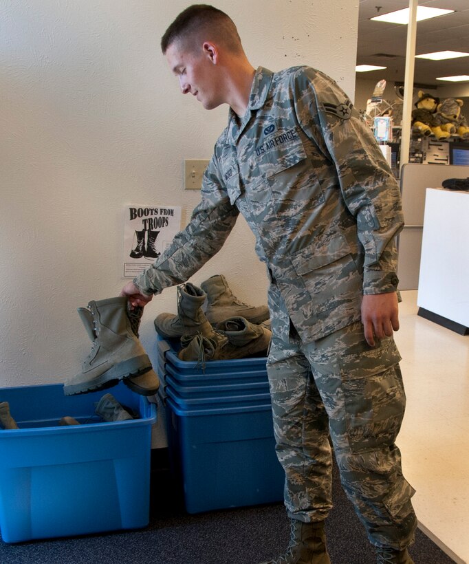 Airman 1st Class Thomas Acord, 366th Training Squadron operations management graduate, deposits a pair of military boots in support of the “Boots from Troops” donation drive May 5, 2014, at the military clothing sales shop on Sheppard Air Force Base, Texas. The drive was started by an airmen leadership class in December 2013 to provide for homeless veterans and other in the local area who are in need. (U.S. Air Force photo/Airman 1st Class Robert L. McIlrath)