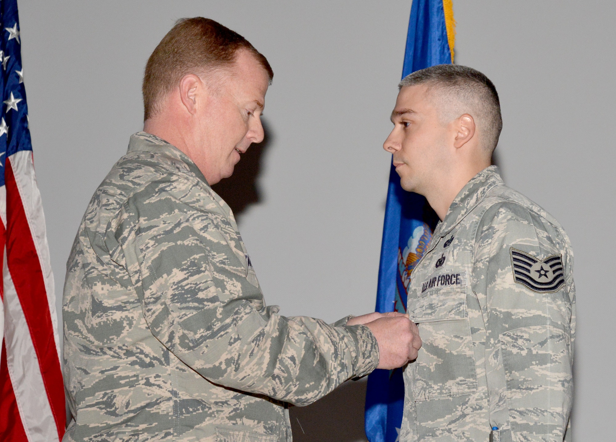 Col. Clifford Stansell (right), Air Force Nuclear Weapons Center vice commander, pins the Purple Heart Medal on Tech. Sgt. Austin Hardin at a ceremony April 29. Austin also received the Bronze Star Medal for acts of bravery following a car bombing while deployed in October 2013. (Photo by Ken Moore)