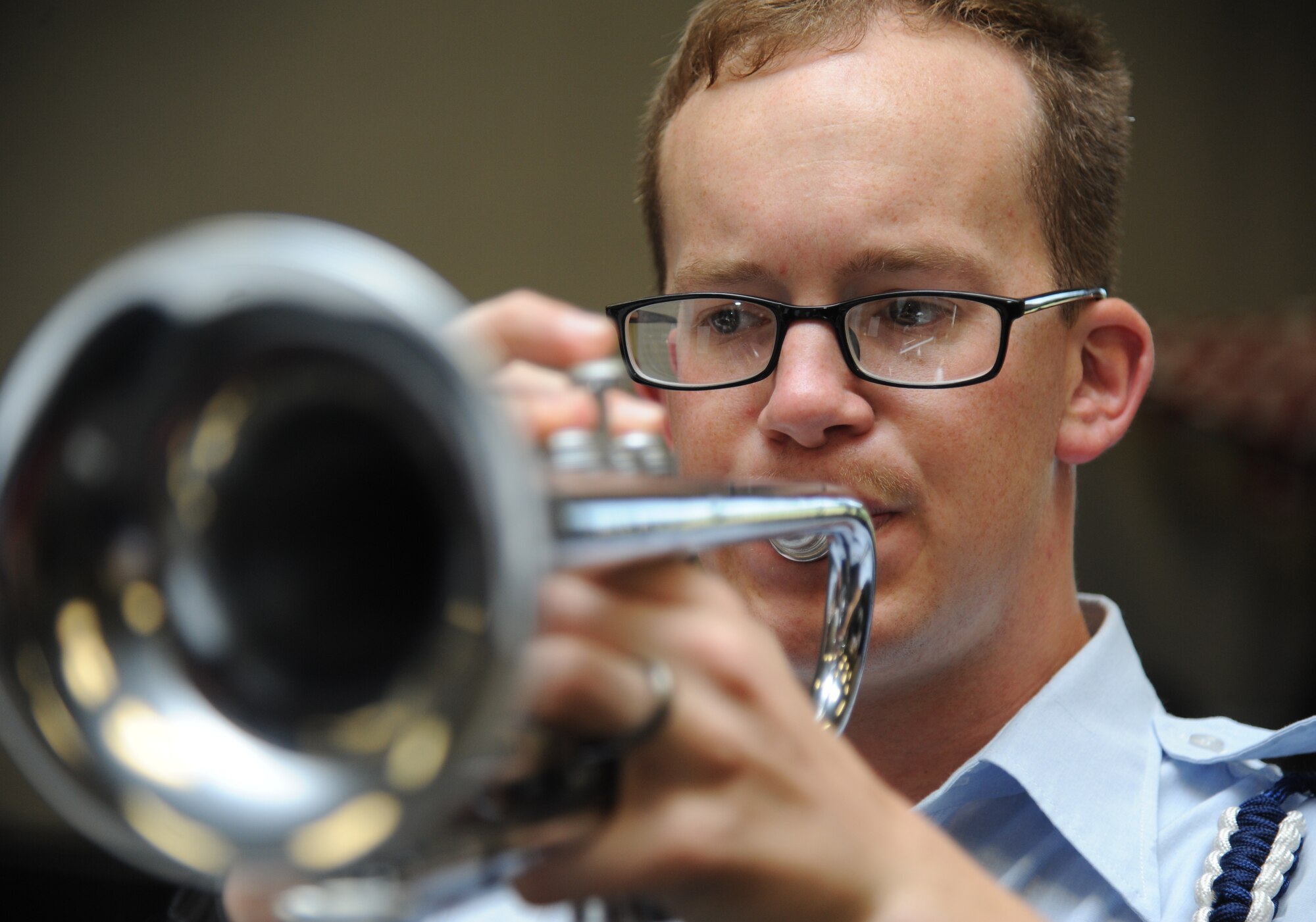 Airman 1st Class Kevin Burg, 335th Training Squadron, plays his trumpet during Drum and Bugle Corps. practice May 12, 2014, at the Levitow Training Support Facility, Keesler Air Force Base, Miss.  He is the 81st Training Group’s Airman of the Month for April.  Burg, from Burlington, Wis., is currently training in the weather apprentice course.  The four squadrons that train nonprior service students each select one Airman to compete at a monthly group board. The Airmen respond to questions about customs and courtesies, dress and appearance, enlisted force development and current events from that week’s issue of the Kee¬sler News.  (U.S. Air Force photo by Kemberly Groue)
