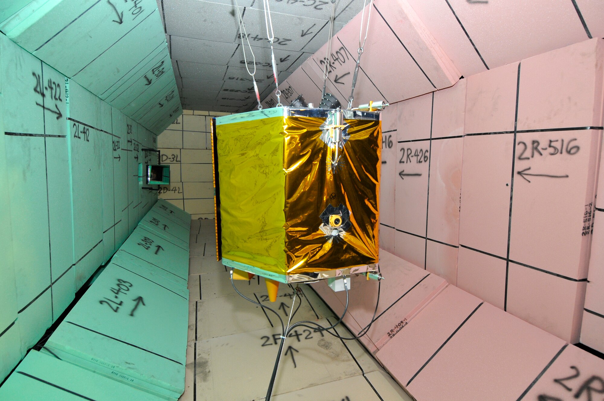 The DebriSat, a non-functional full-scale representation of a modern satellite, is shown in the Range G target tank surrounded by "soft catch." (Photo by Jacqueline Cowan)