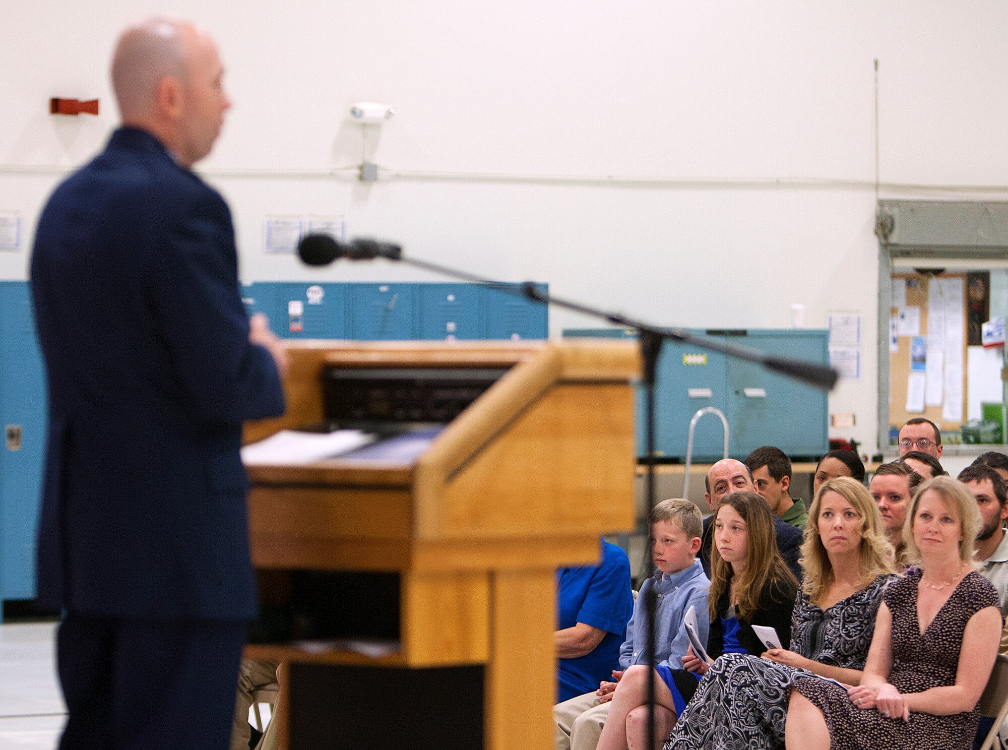 Angie Allen, second from right, along with her children Kylie, 10, and Jackson, 9, listens as her husband Col. Ron Allen, 90th Operations Group commander, speaks shortly after assuming command of the group during a ceremony in the 37th Helicopter Squadron hanger, Bldg. 1250, at F.E. Warren Air Force Base, Wyo., May 9, 2014. (U.S. Air Force photo by R.J. Oriez)