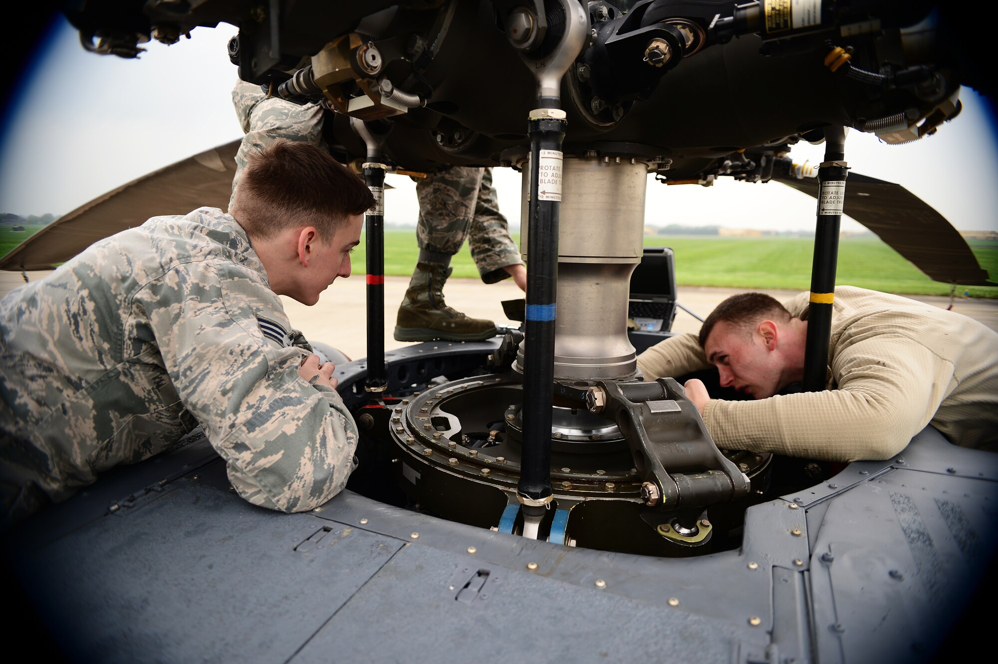 Senior Airman Clinton Sheppard, 748th Aircraft Maintenance Squadron crew chief, left, and Senior Airman Joshua VanBallegooie, 748th AMXS aerospace propulsion technician, perform torque checks on an HH-60G Pave Hawk at Royal Air Force Leeming, England, April 30, 2014. Maintenance Airmen conduct routine maintenance checks before and after flights to ensure minimal delays before takeoff. (U.S. Air Force photo by Staff Sgt. Emerson Nuñez/Released)