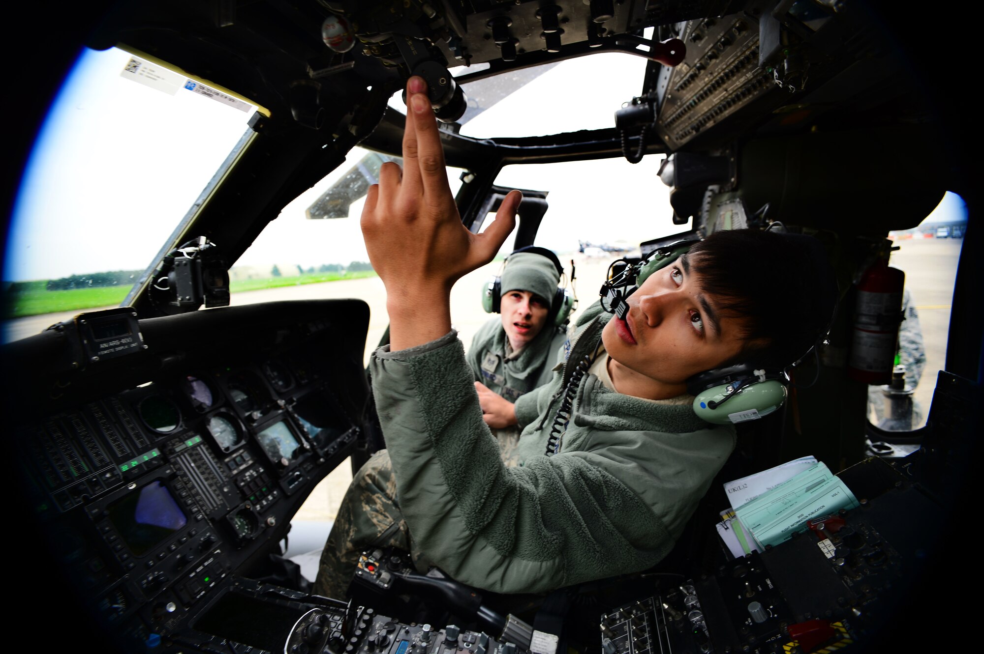 Staff Sgt. Quinton Harward, 748th Aircraft Maintenance Squadron crew chief, back, trains Airman 1st Class Dylan Shephard, 748th AMXS crew chief, on auxiliary power start up procedures on an HH-60G Pave Hawk at Royal Air Force Leeming, England, April 30, 2014. Maintenance Airmen spent a week at RAF Leeming ensuring 56th Rescue Squadron HH-60Gs were prepared for electronic warfare training. (U.S. Air Force photo by Staff Sgt. Emerson Nuñez/Released)