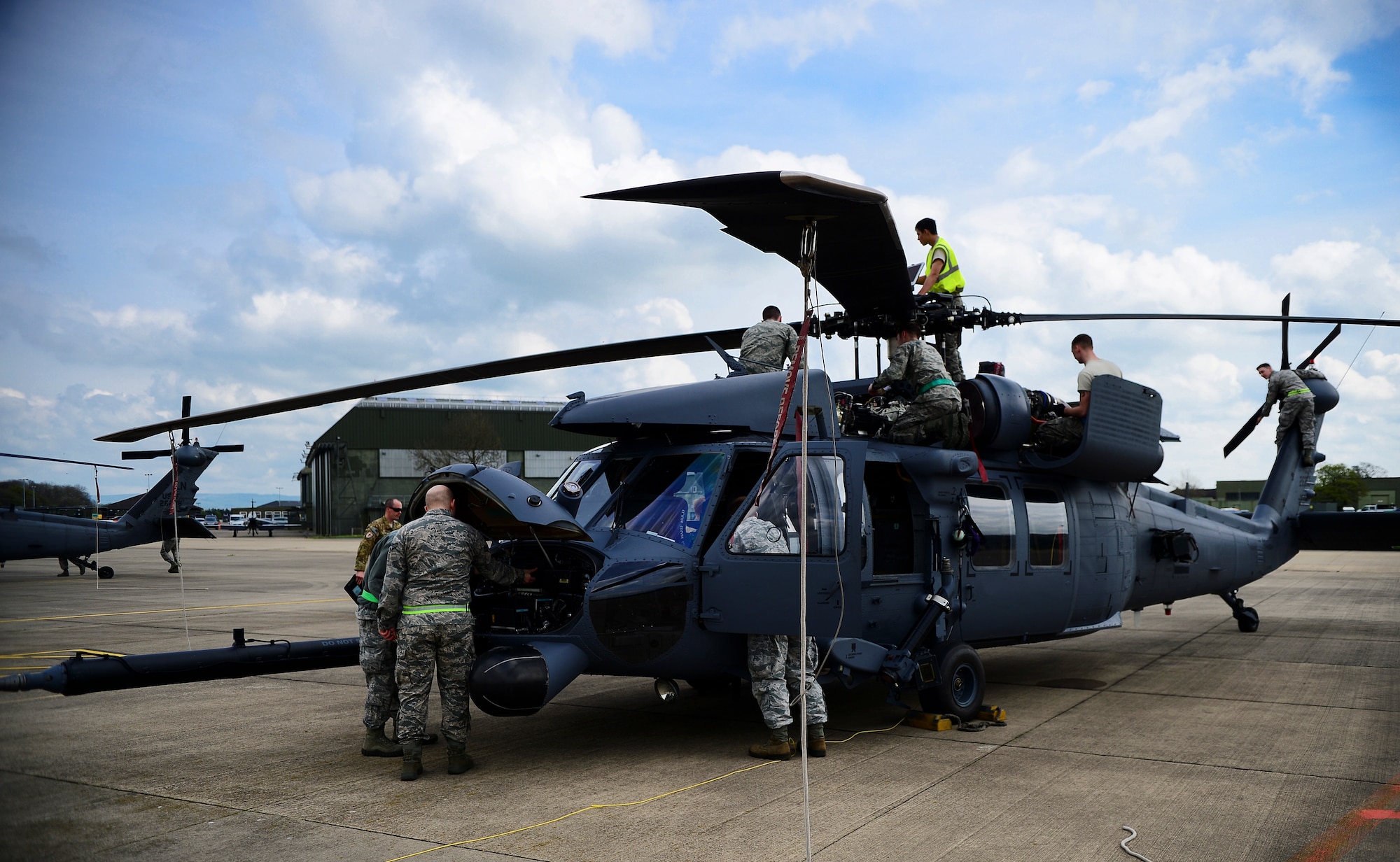 Members of the 748th Aircraft Maintenance Squadron conduct post-flight inspections on an HH-60G Pave Hawk at Royal Air Force Leeming, England, April 28, 2014. Airmen conduct routine maintenance checks before and after flights to ensure minimal delays before takeoff. (U.S. Air Force photo by Staff Sgt. Emerson Nuñez/Released)
