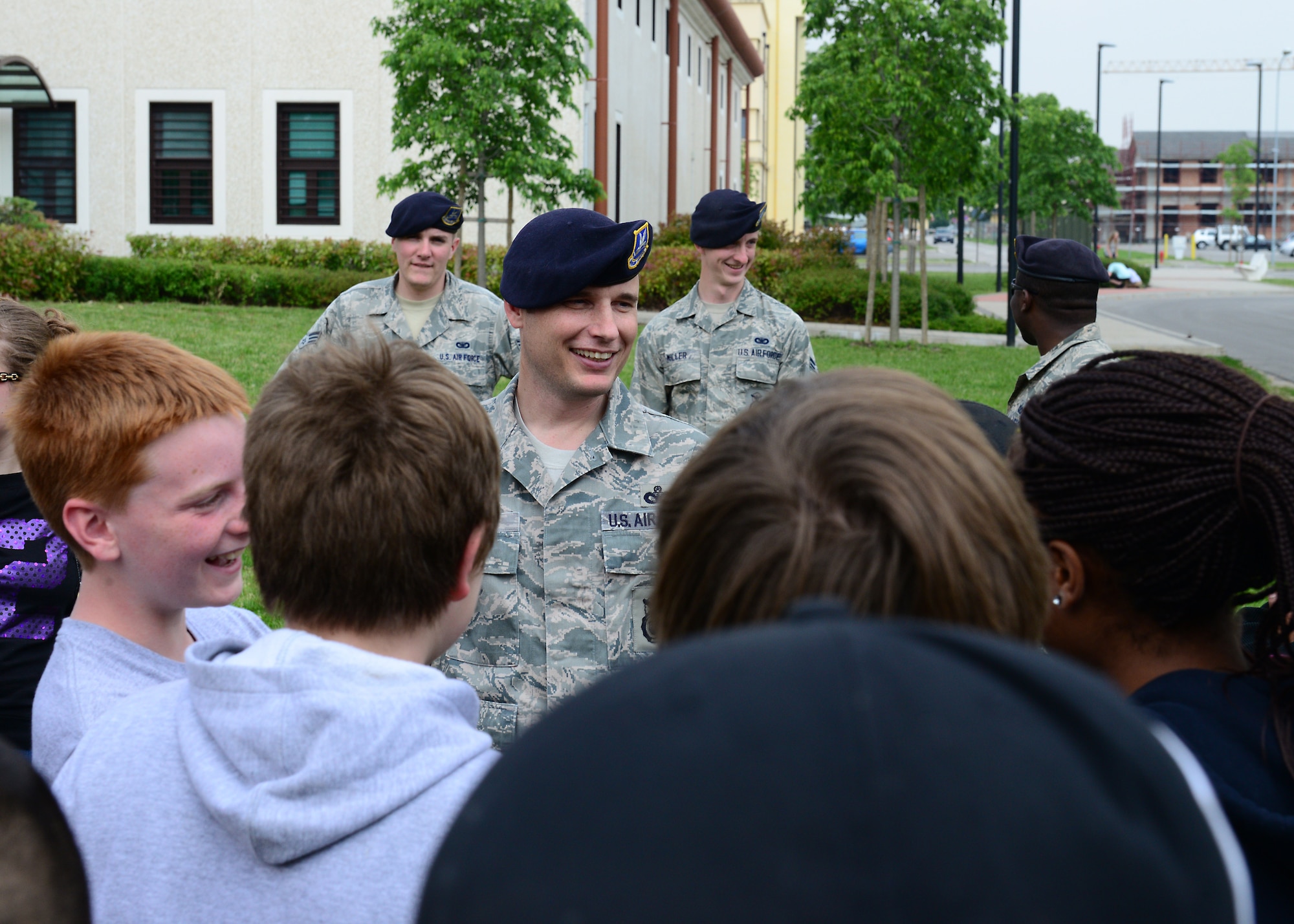 Chief Master Sgt. Scott King, 31st Security Forces Squadron manager, talks to a group of school-aged children during an annual job shadow day, May 9, 2014, at Aviano Air Base, Italy. Approximately 160 school-aged kids were allowed the opportunity to experience the routine and rigors of a typical work day through the eyes of firemen, law enforcement officials, medical personnel and more during the base-wide event. (U.S. Air Force photo/Airman 1st Class Ryan Conroy)  
