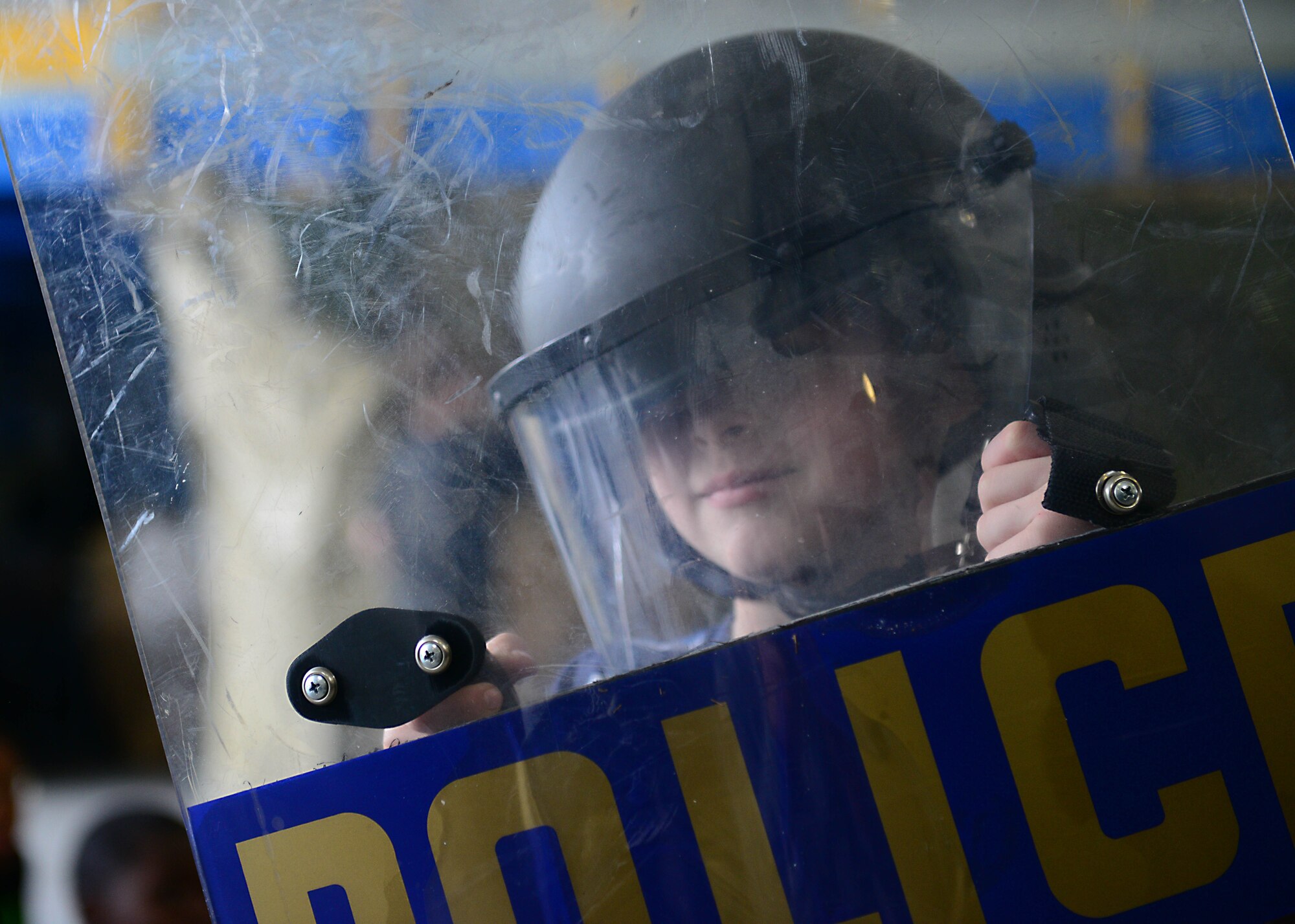 Jonathan Cloyd, son of Tech. Sgt. David Cloyd, 31st Logistics Readiness Squadron, dons riot gear during an annual job shadow day, May 9, 2014, at Aviano Air Base, Italy. Approximately 160 school-aged kids were allowed the opportunity to experience the routine and rigors of a typical work day through the eyes of firemen, law enforcement officials, medical personnel and more during the base-wide event. (U.S. Air Force photo/Airman 1st Class Ryan Conroy)  