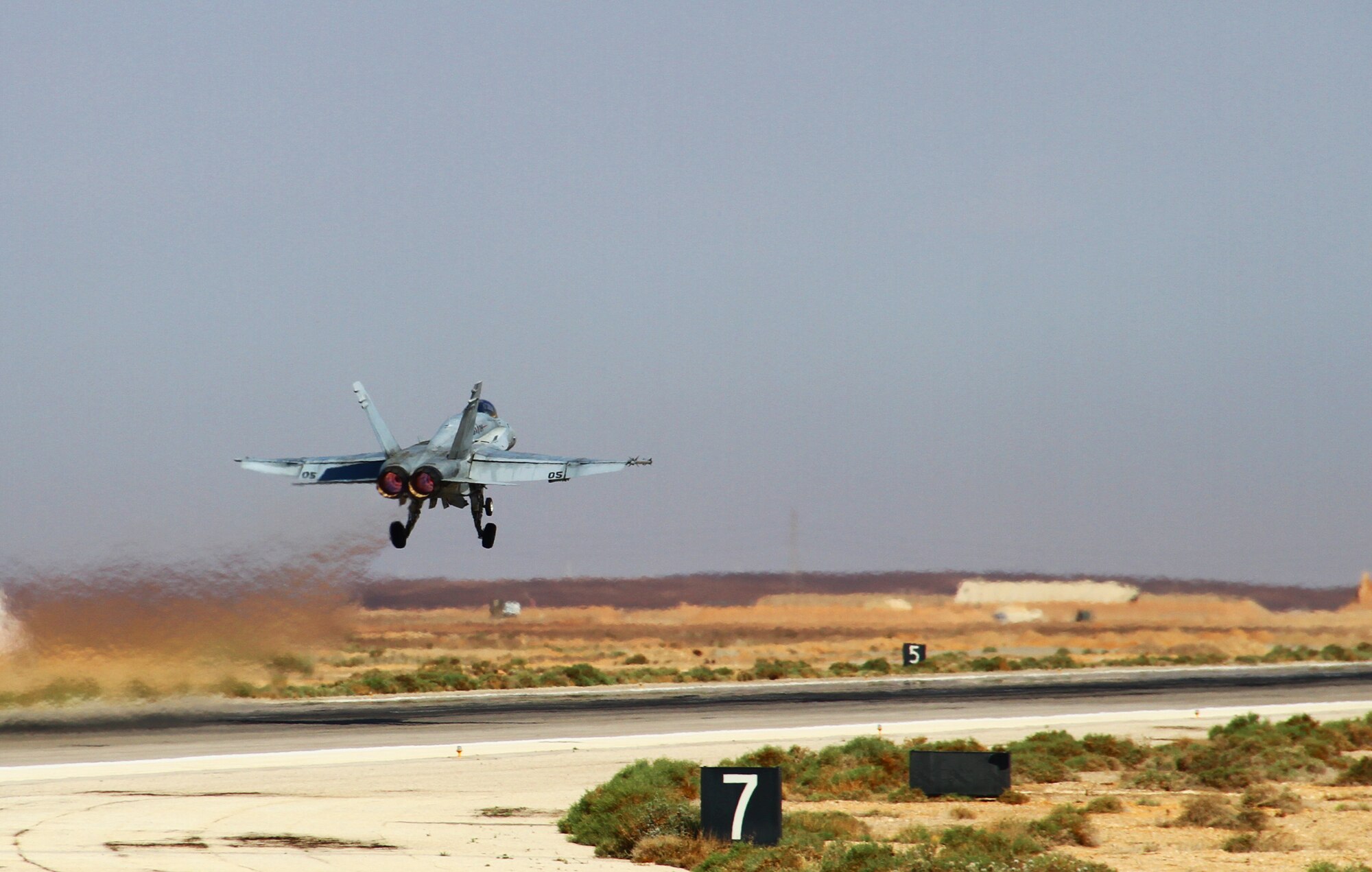 An F-18 Hornet assigned to the Marine Air Group 50 at Marine Corps Air Station Miramar, Calif., launches to join flying operations after a scramble competition during Exercise Eager Tiger May 12, 2014, at an air base in northern Jordan. This exercise is a multinational exercise and designed to enhance partnerships and interoperability between U.S and Jordanian forces. (U.S. Air Force photo by Staff Sgt. Tyler McLain/Released)