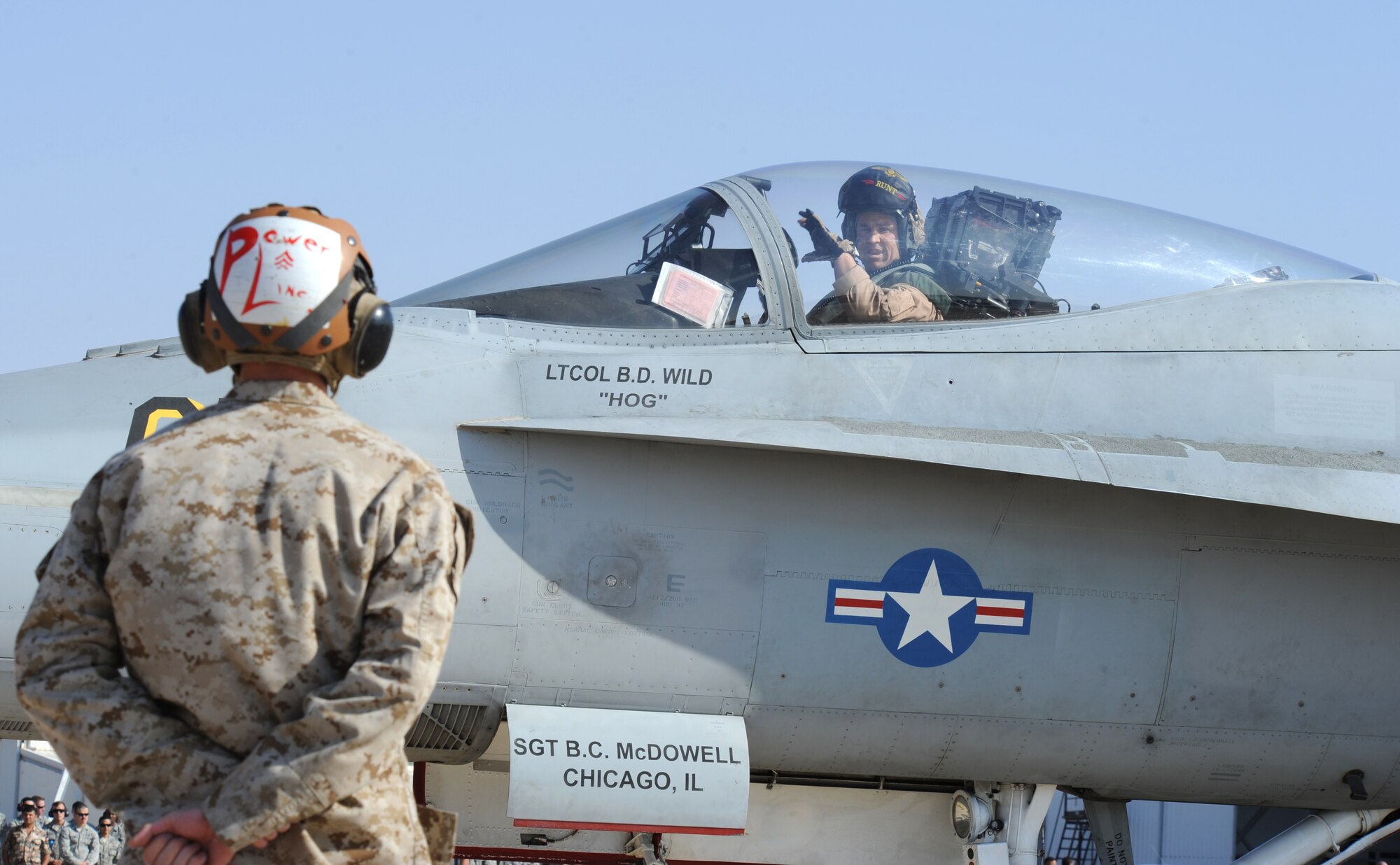 Members assigned to the Marine Air Group 50 at Marine Corps Air Station Miramar, Calif., prepare an F-18 Hornet for takeoff during a scramble competition at Exercise Eager Tiger May 12, 2014, at an air base in northern Jordan. This annual exercise provides fighter aircraft crews from the U.S. and Jordanian militaries a chance to conduct joint operations which enhance interoperability. (U.S. Air Force photo by Staff Sgt. Brigitte N. Brantley/Released)