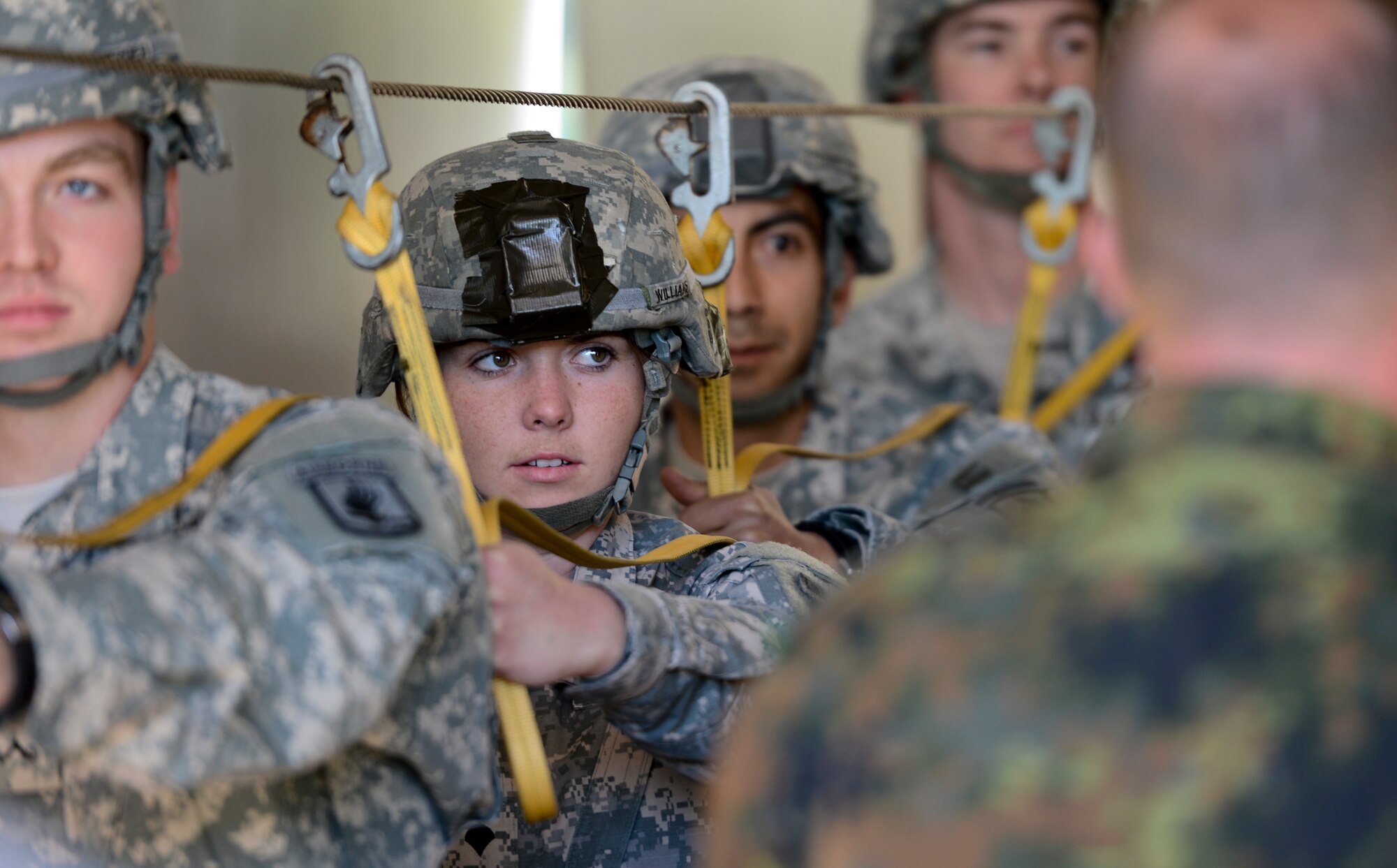 A U.S. solider participates in a proper aircraft exiting technique exercise during International Jump Week May 4, 2014, at Rhine Ordinance Barracks, Germany. Airmen and soldiers built camaraderie with partner nations, learning their exiting techniques and commands within an aircraft. (U.S. Air Force photo/Airman 1st Class Michael Stuart)