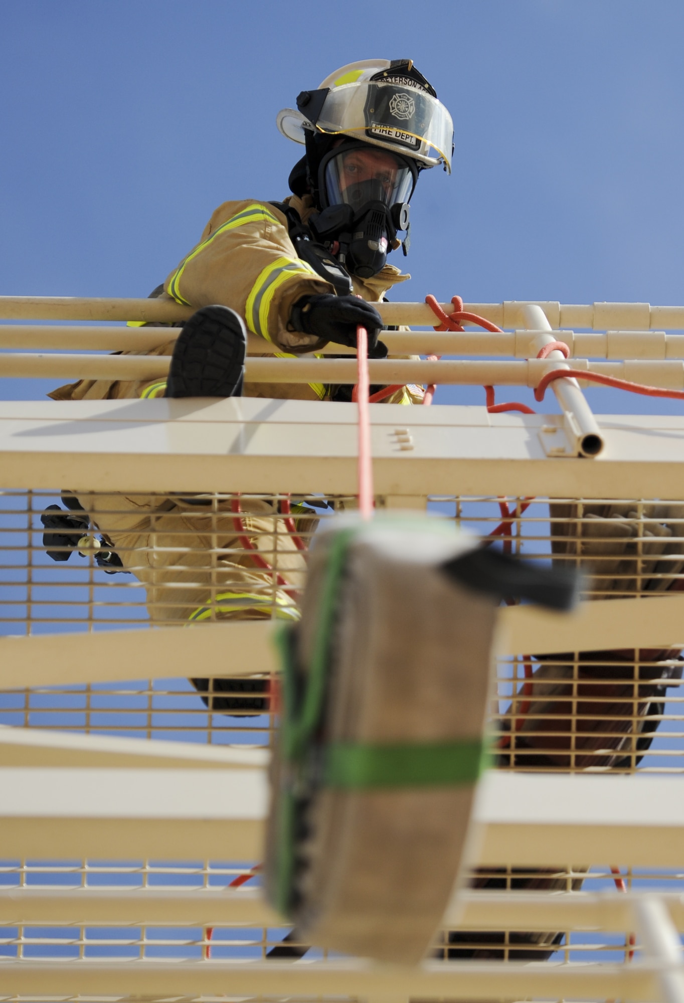 PETERSON AIR FORCE BASE, Colo. – Lt. Col. Joshua Demotts, 21st Civil Engineer Squadron commander, pulls a hose up five stories during a training exercise May 9 here. The exercise included wing leadership and consisted of the unofficial firefighter physical fitness test and a confidence burn. (U.S. Air Force photo/Staff Sgt. Jacob Morgan)