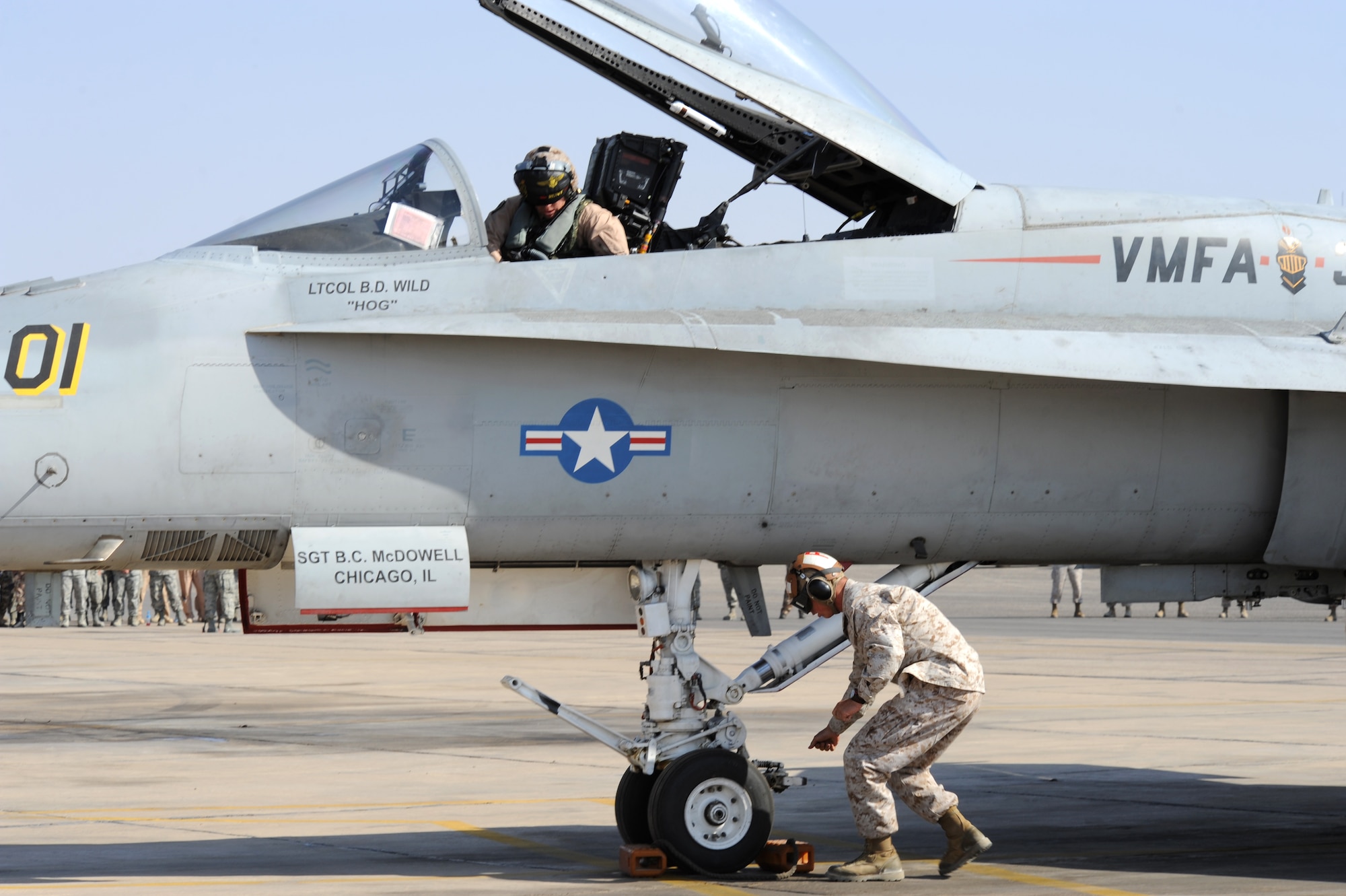 Members assigned to Marine Air Group 50 at Marine Corps Air Station Miramar, Calif., rush to prepare their F-18 Hornet during a scramble competition at Exercise Eager Tiger May 12, 2014, at an air base in northern Jordan. Throughout the exercise, the Marines also conducted joint flying operations with the U.S. Air Force and Royal Jordanian Air Force. (U.S. Air Force photo by Staff Sgt. Brigitte N. Brantley/Released)